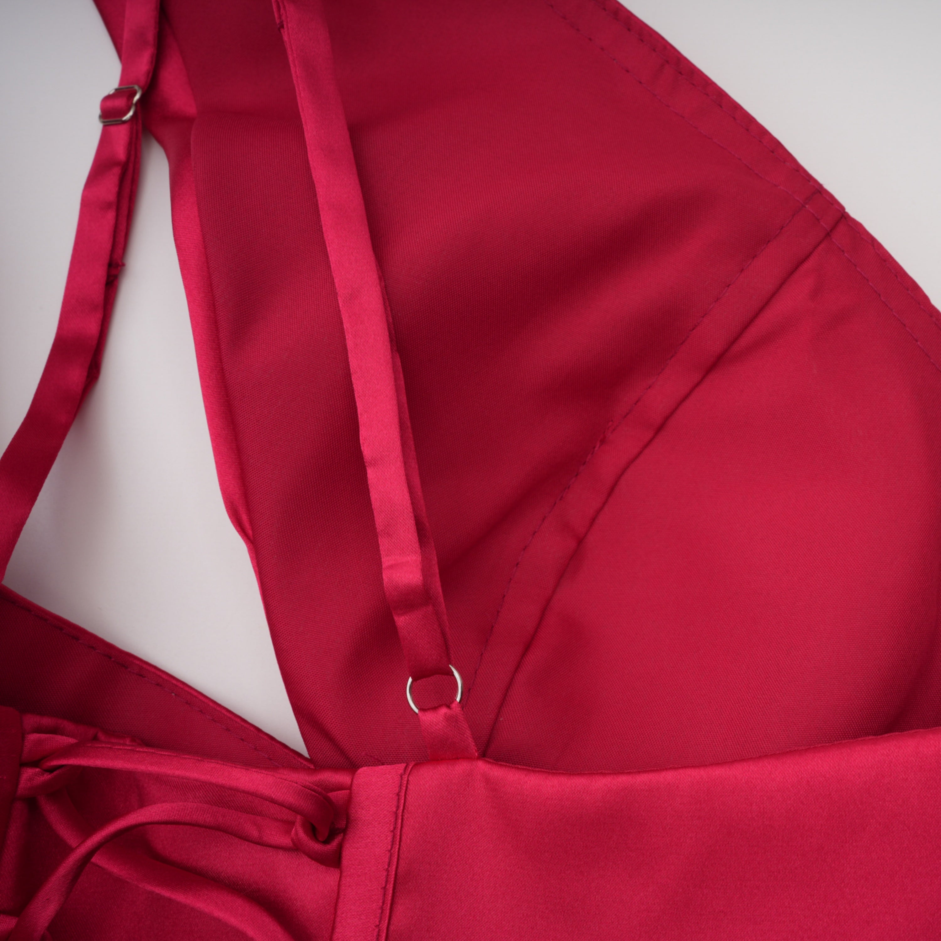 Red one-shoulder satin gown with chest cutout and draped waist