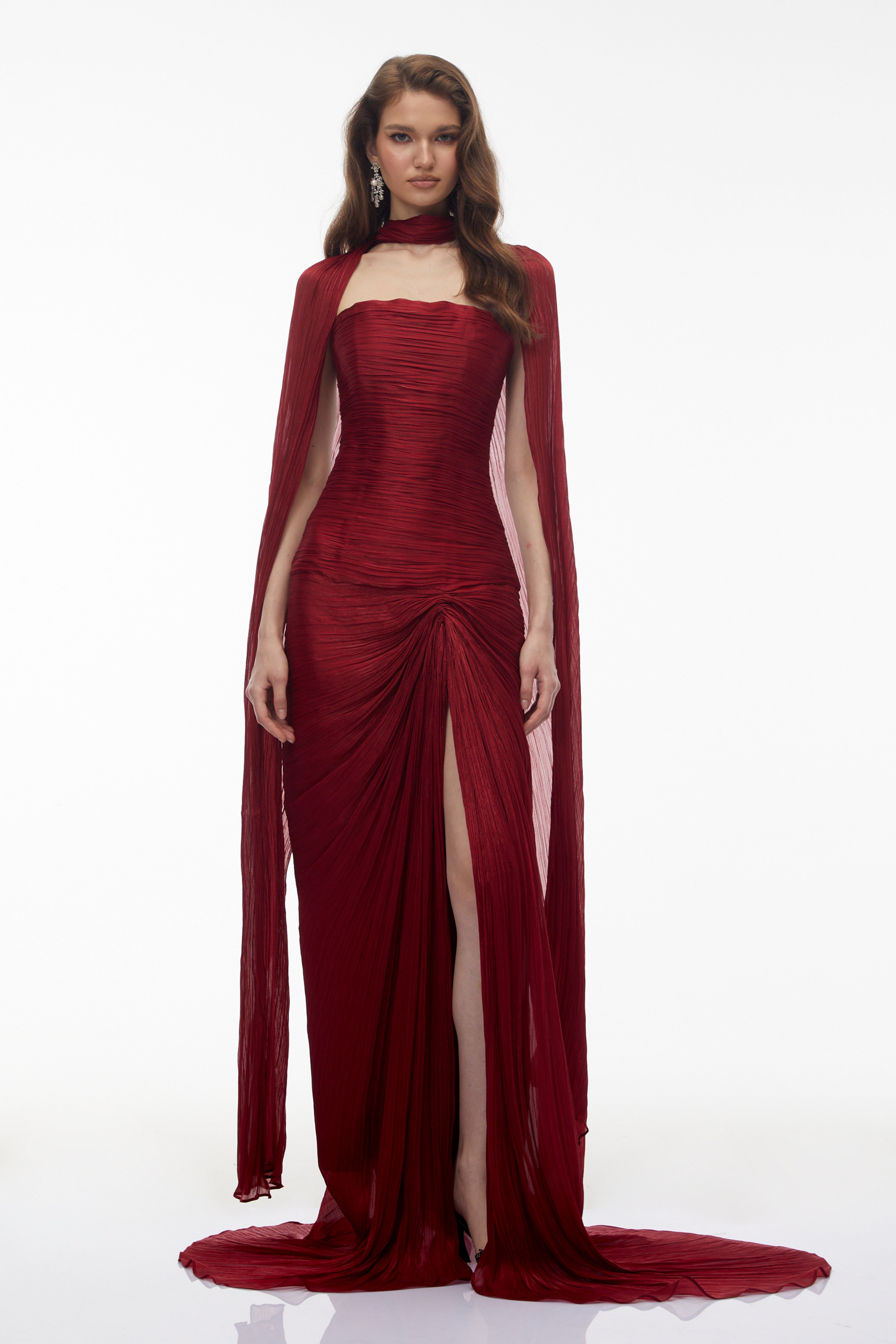 Burgundy pleated strapless gown with matching cape and high slit