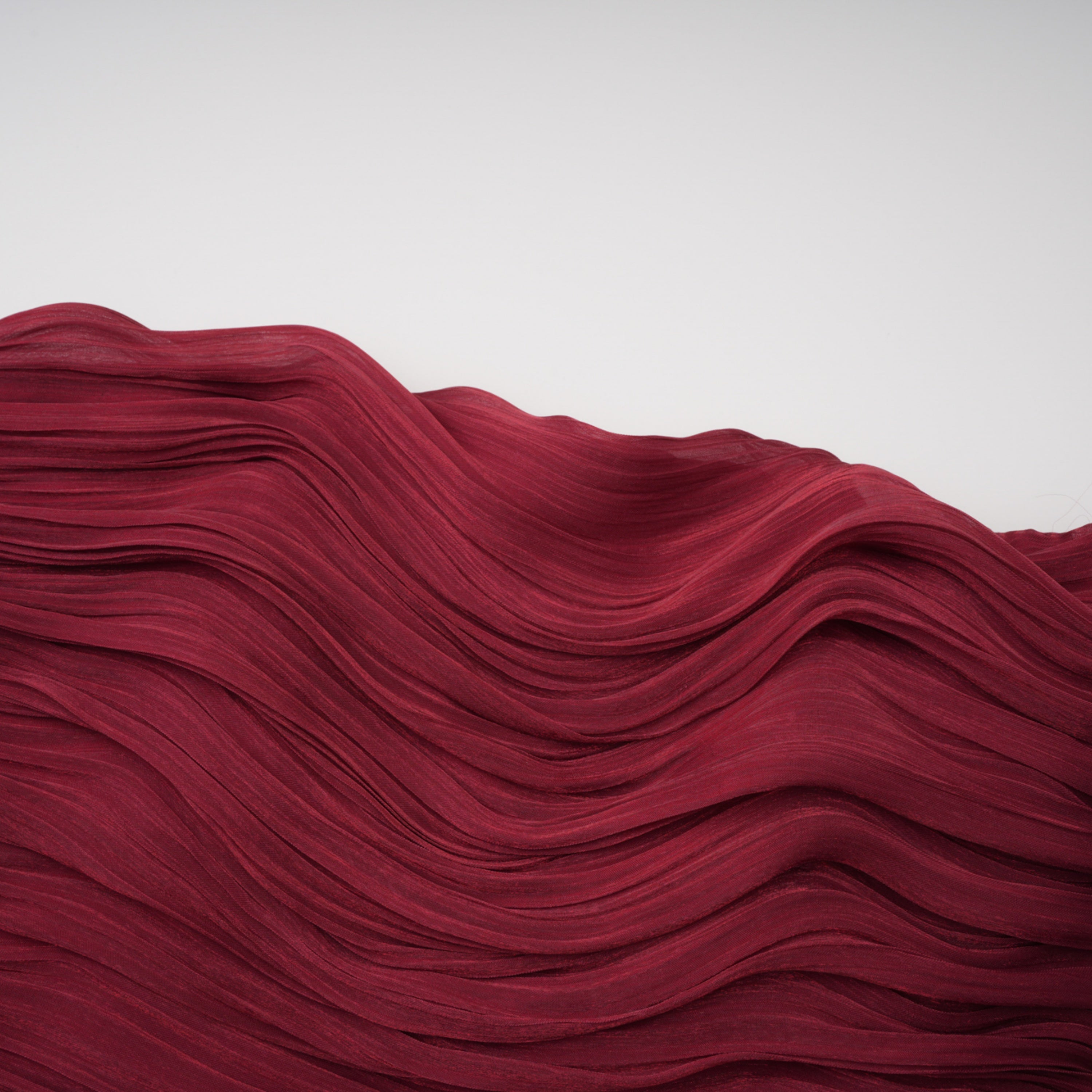 Burgundy pleated strapless gown with matching cape and high slit