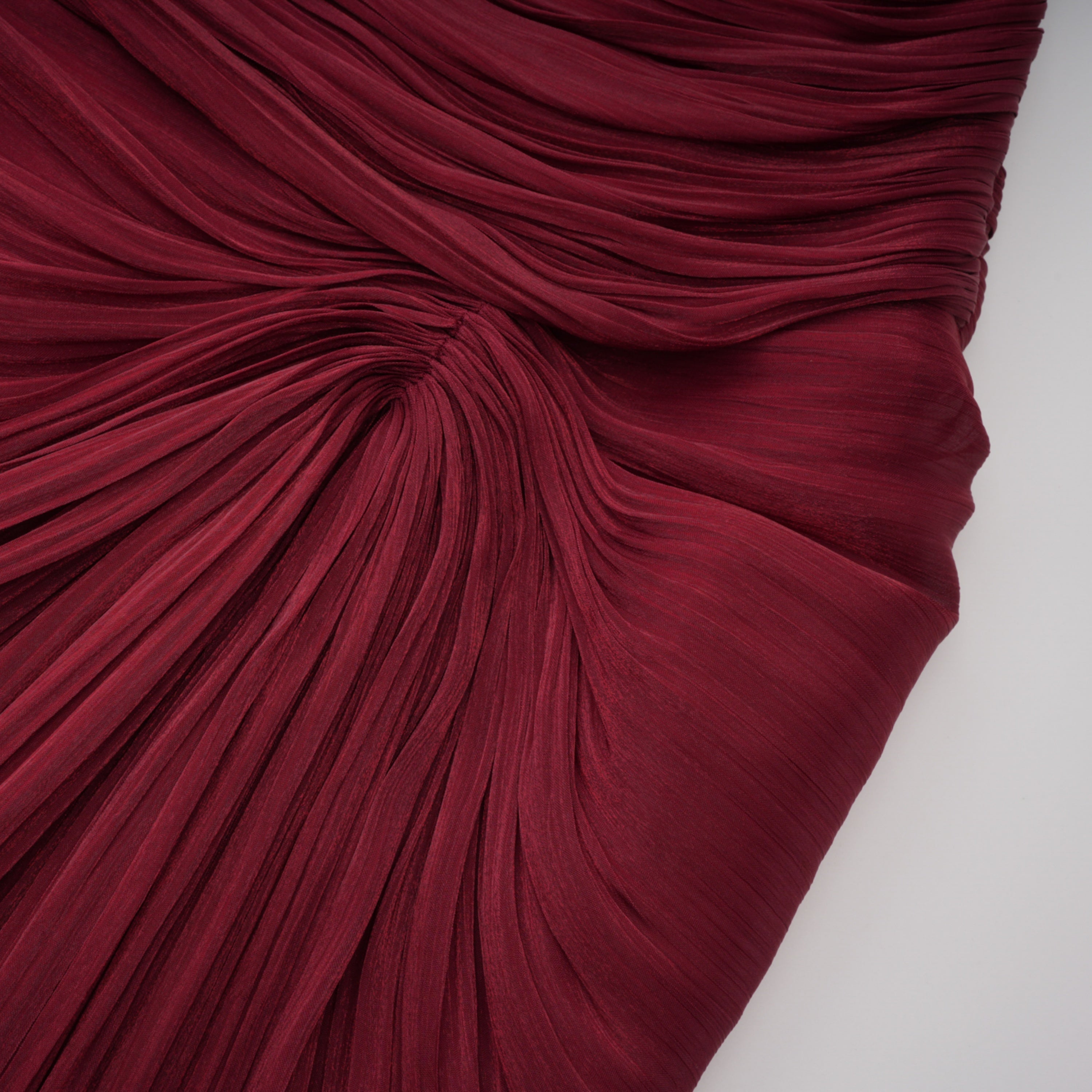 Burgundy pleated strapless gown with matching cape and high slit