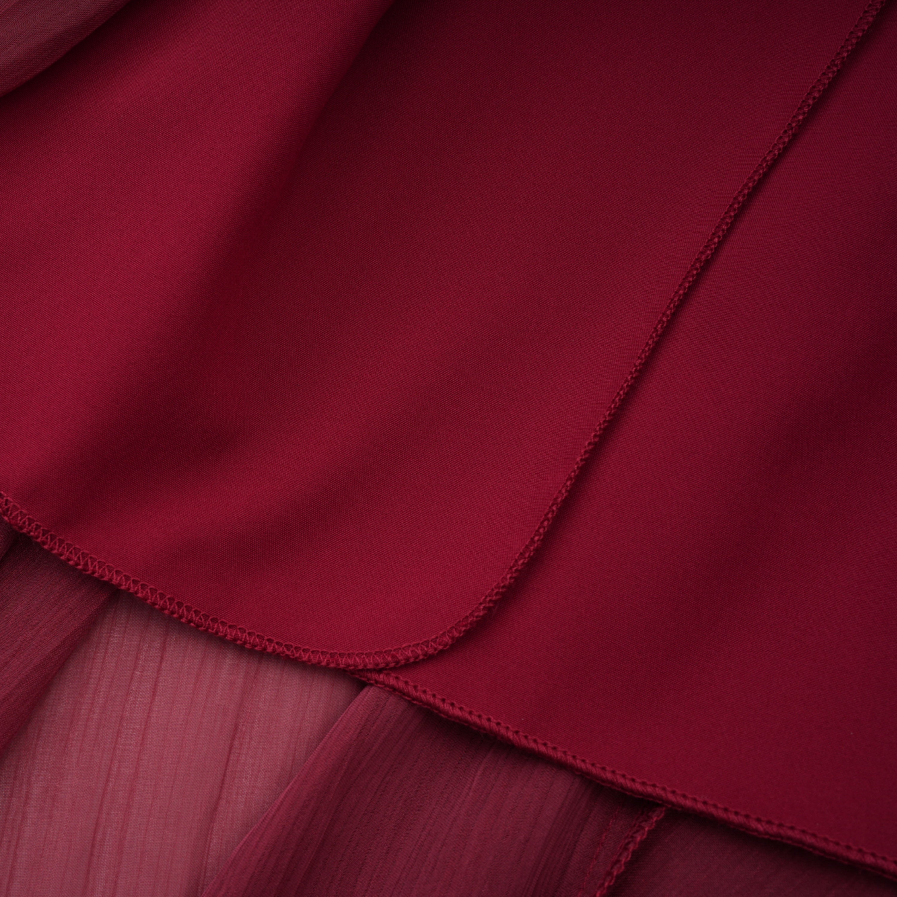 Burgundy pleated strapless gown with matching cape and high slit