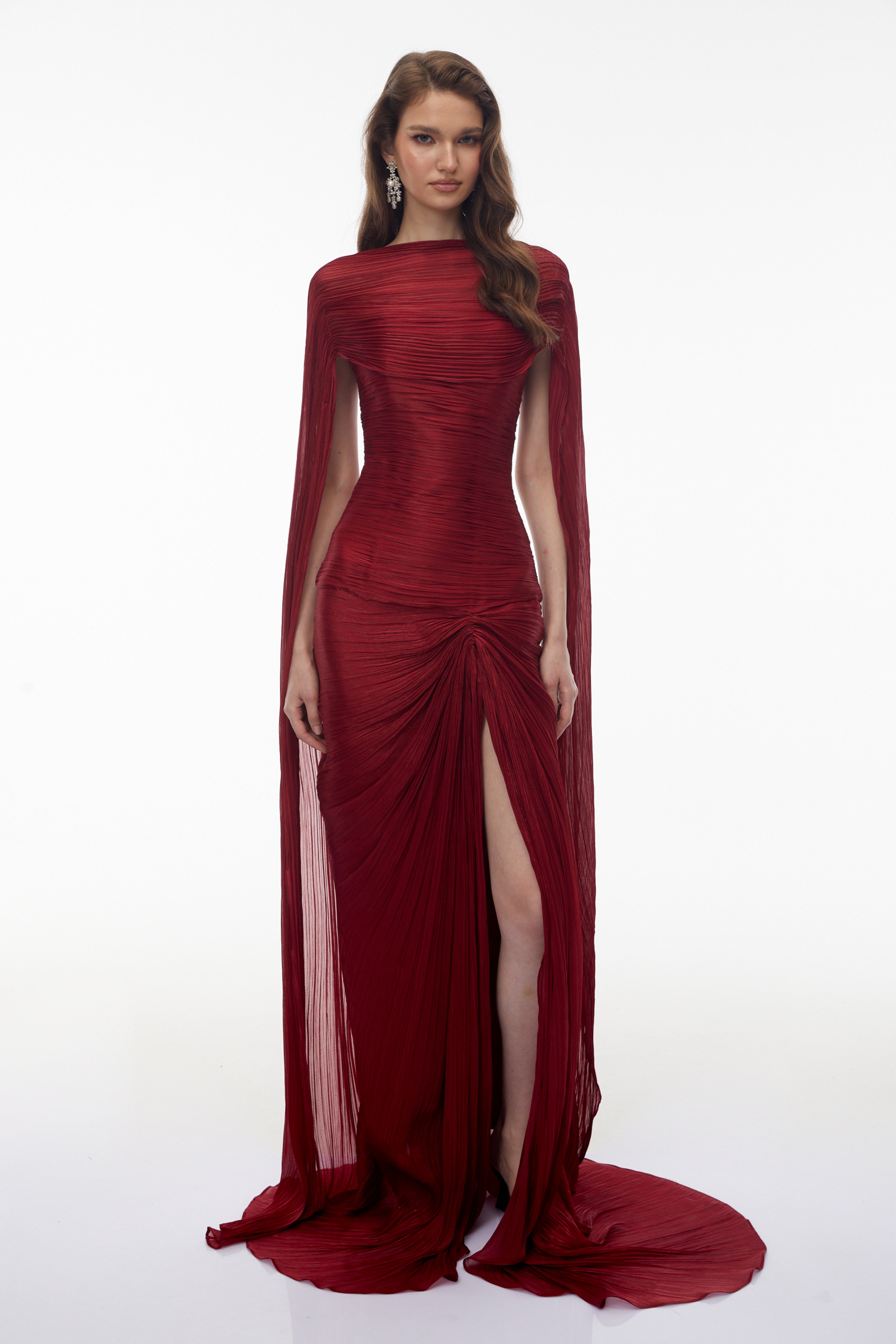 Burgundy pleated strapless gown with matching cape and high slit