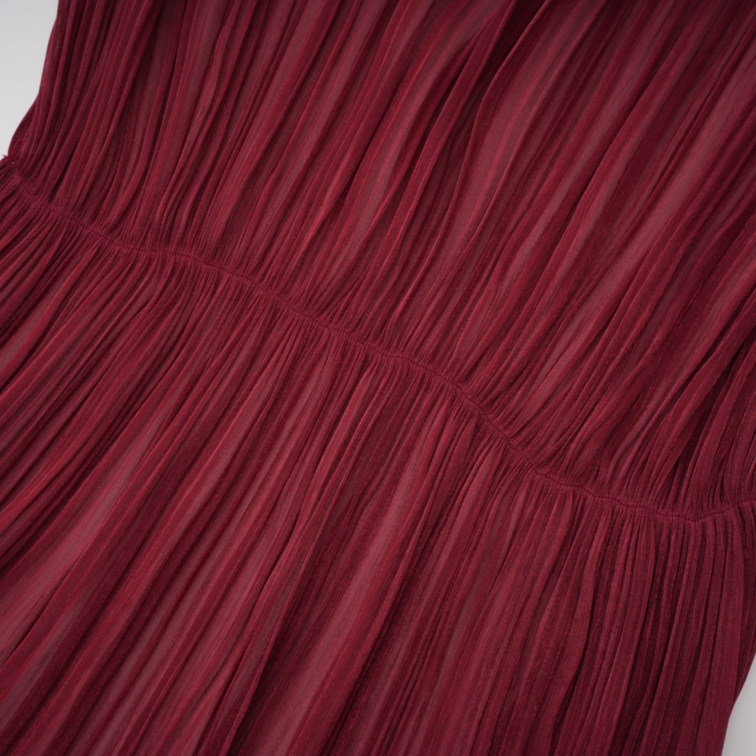 Burgundy pleated strapless gown with matching cape and high slit