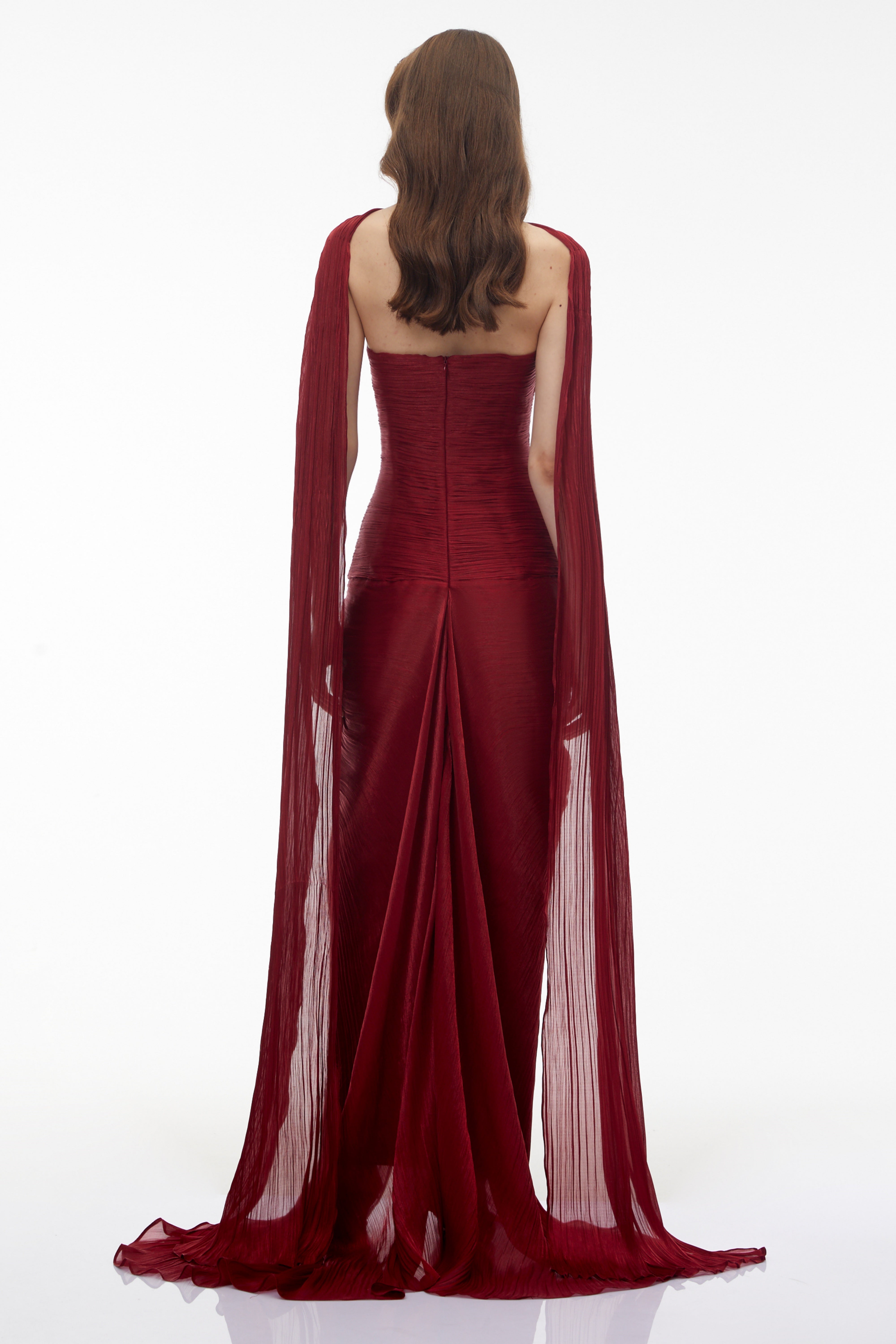 Burgundy pleated strapless gown with matching cape and high slit
