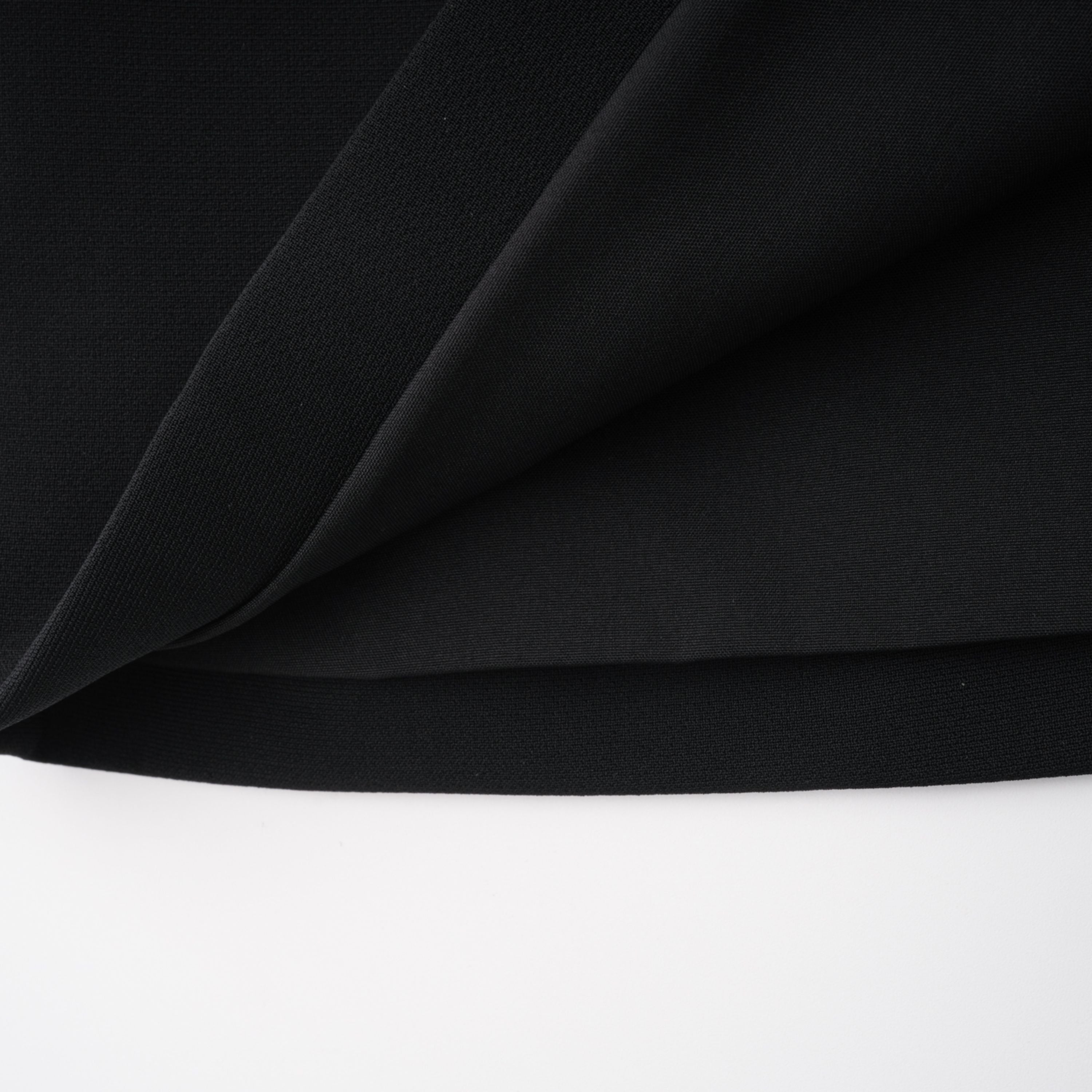 Black structured two-piece midi set with a boxy crop top and an exaggerated hip midi skirt