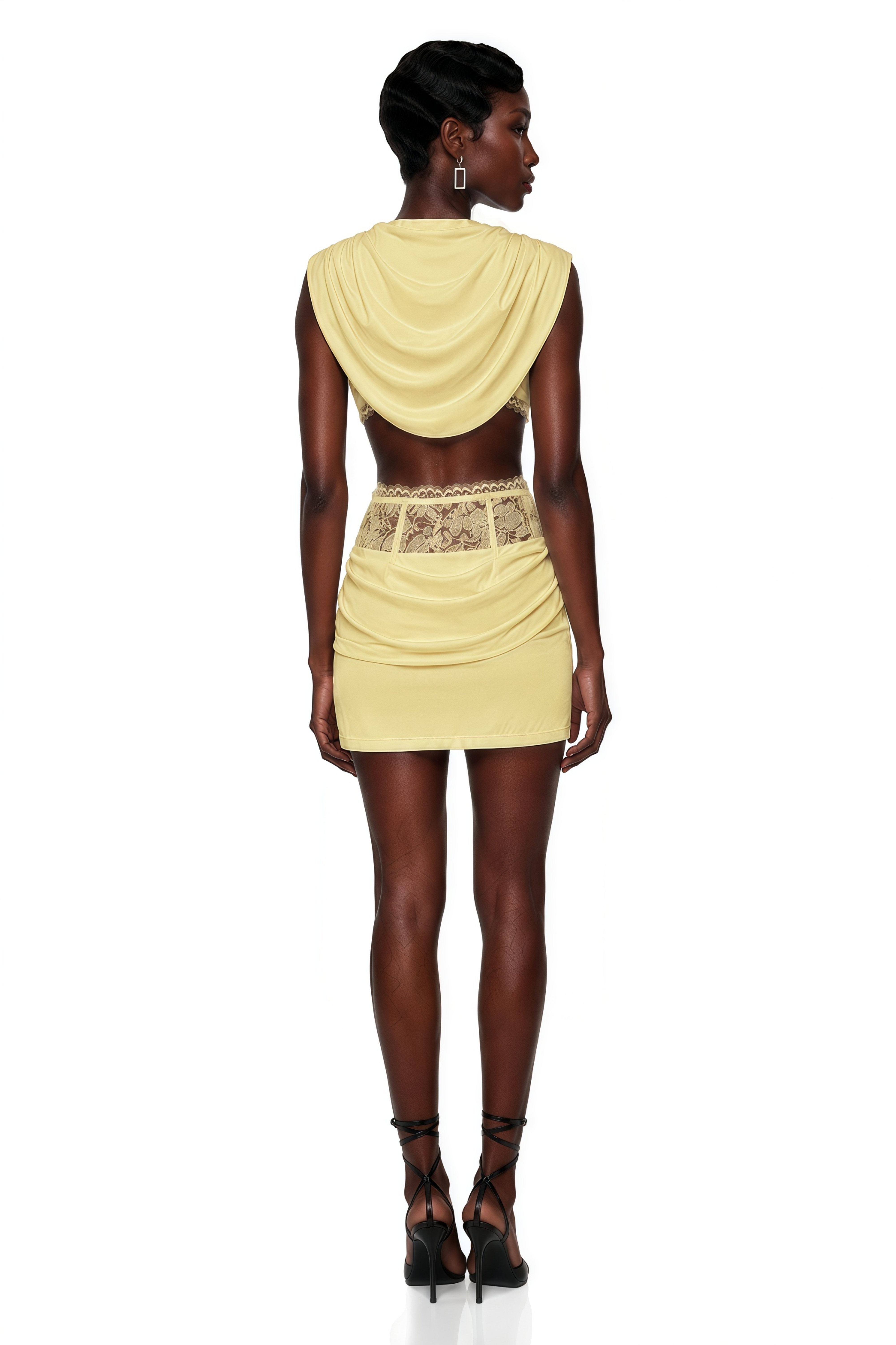 Pale yellow two-piece set with a cowl crop top and a lace-waist mini skirt