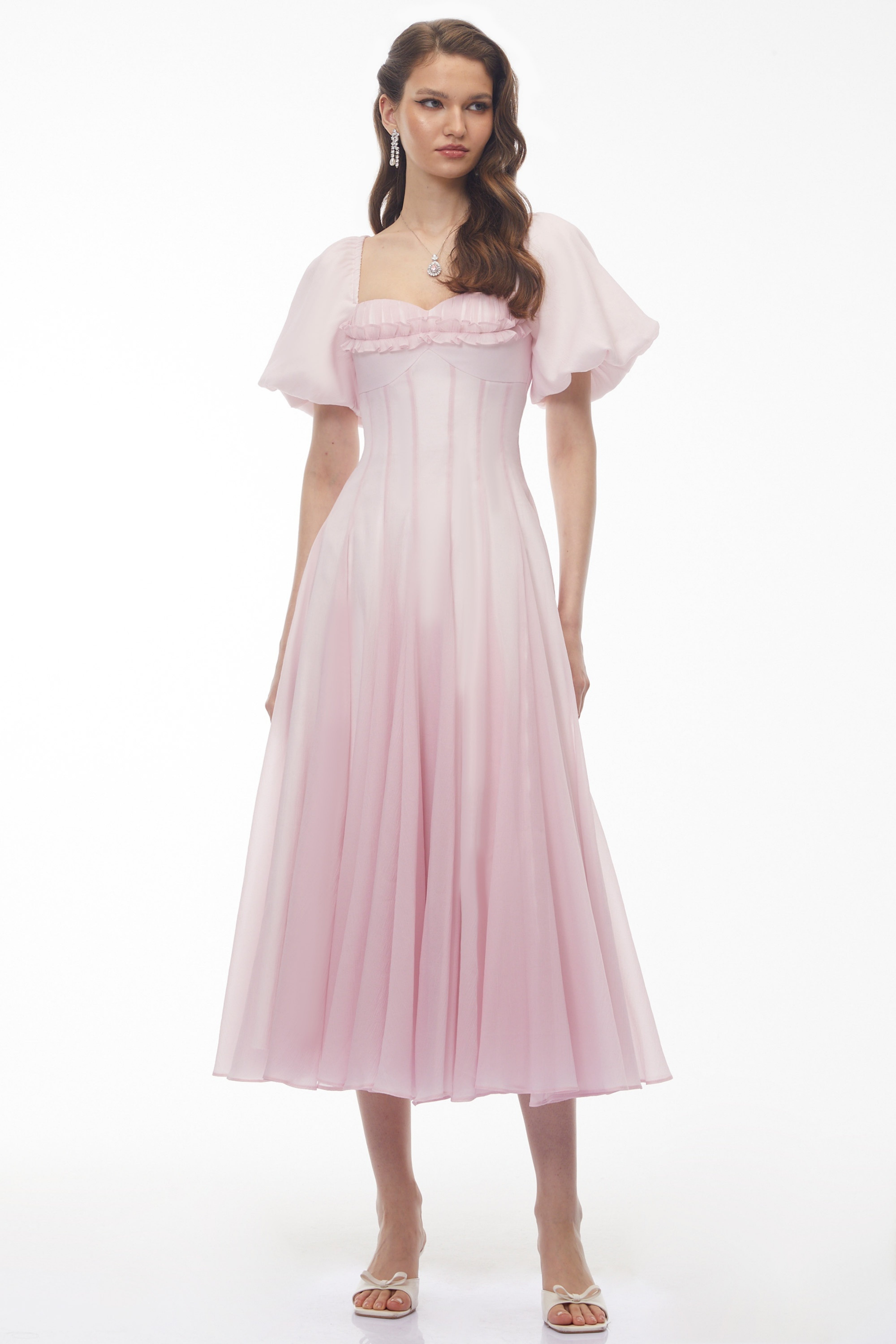 Light pink midi dress with puff sleeves, a ruffled sweetheart neckline, and a pleated skirt