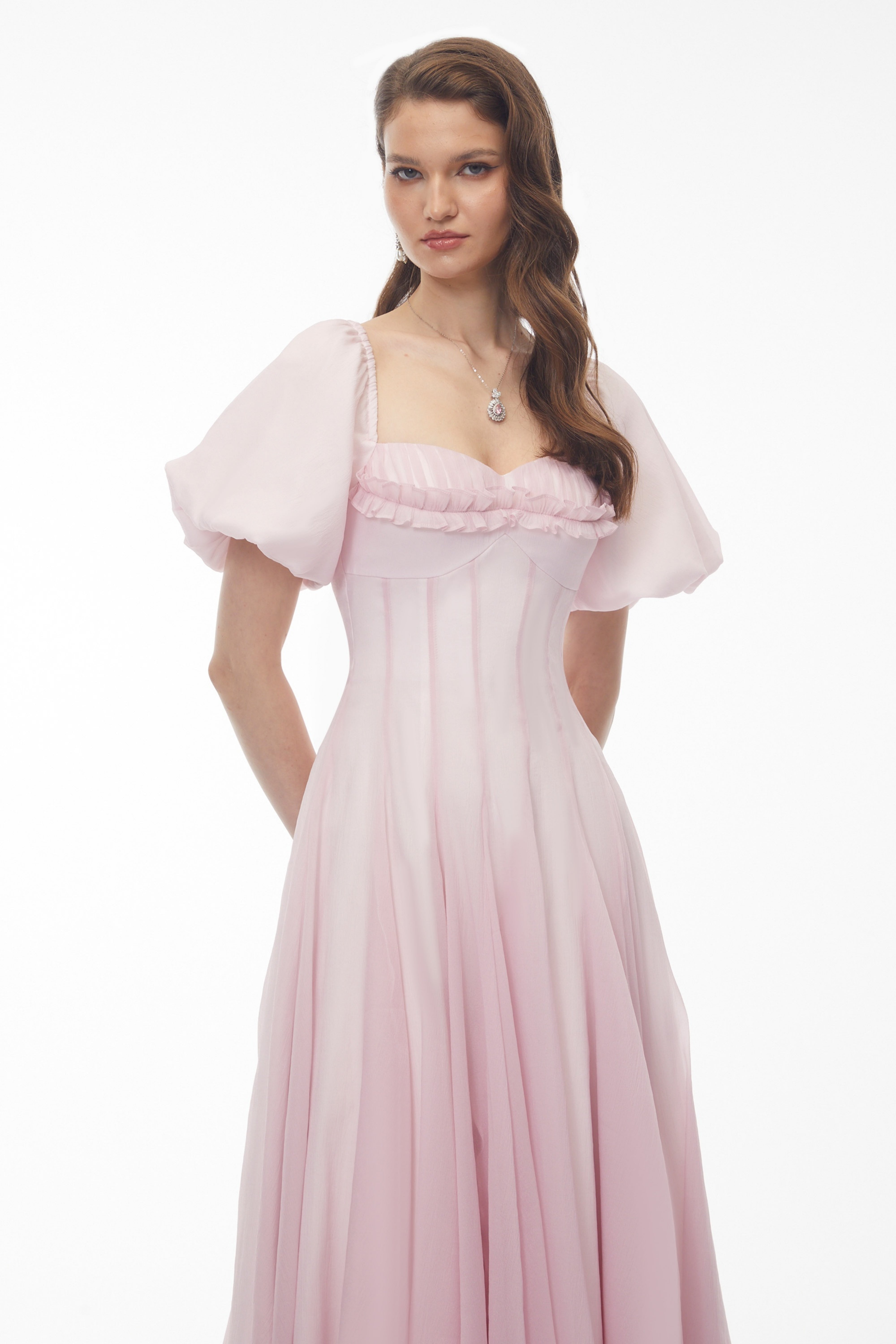 Light pink midi dress with puff sleeves, a ruffled sweetheart neckline, and a pleated skirt