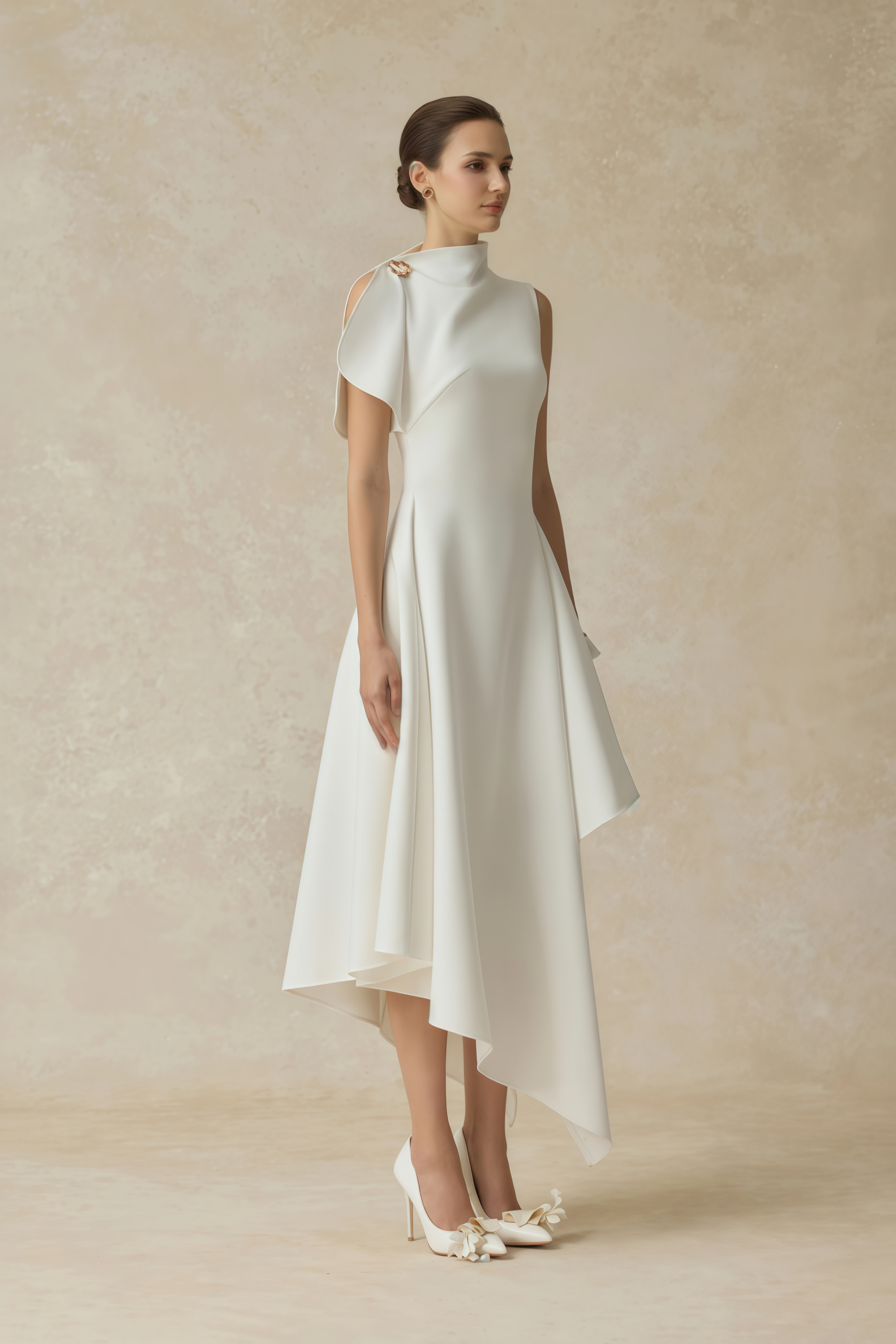 White sleeveless midi dress featuring a high drape neck with a brooch detail and a structured asymmetric handkerchief skirt