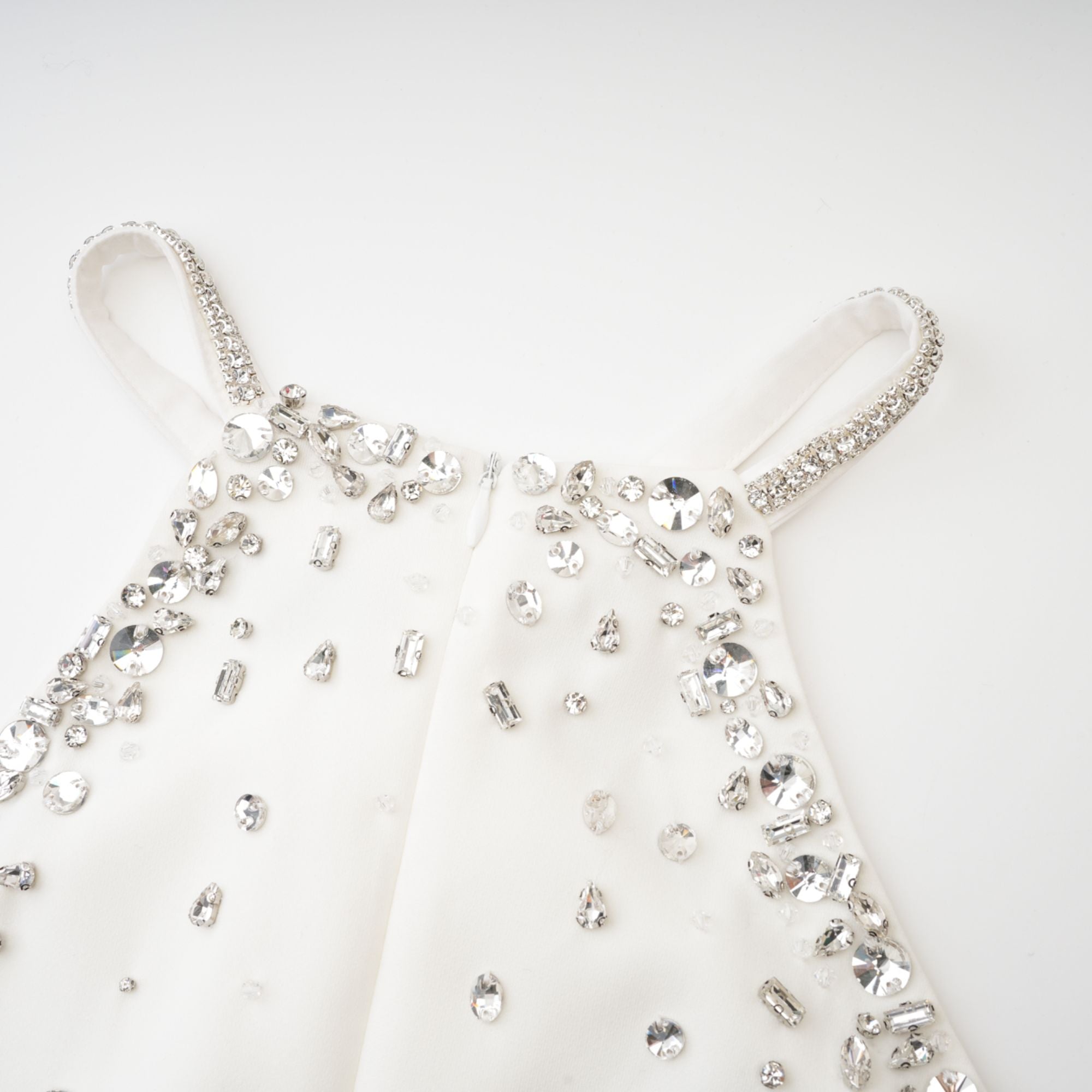 Black halter mini dress embellished with crystals on the neckline and bodice