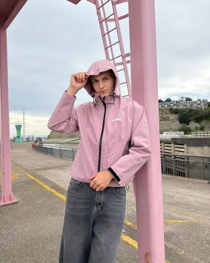 Back view of the pink reactive jacket beside water
