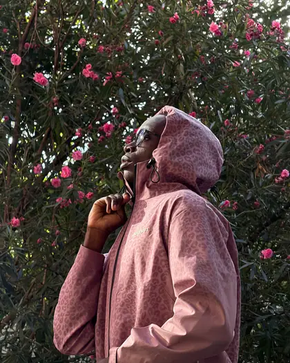 Model wearing the pink reactive jacket on stairs