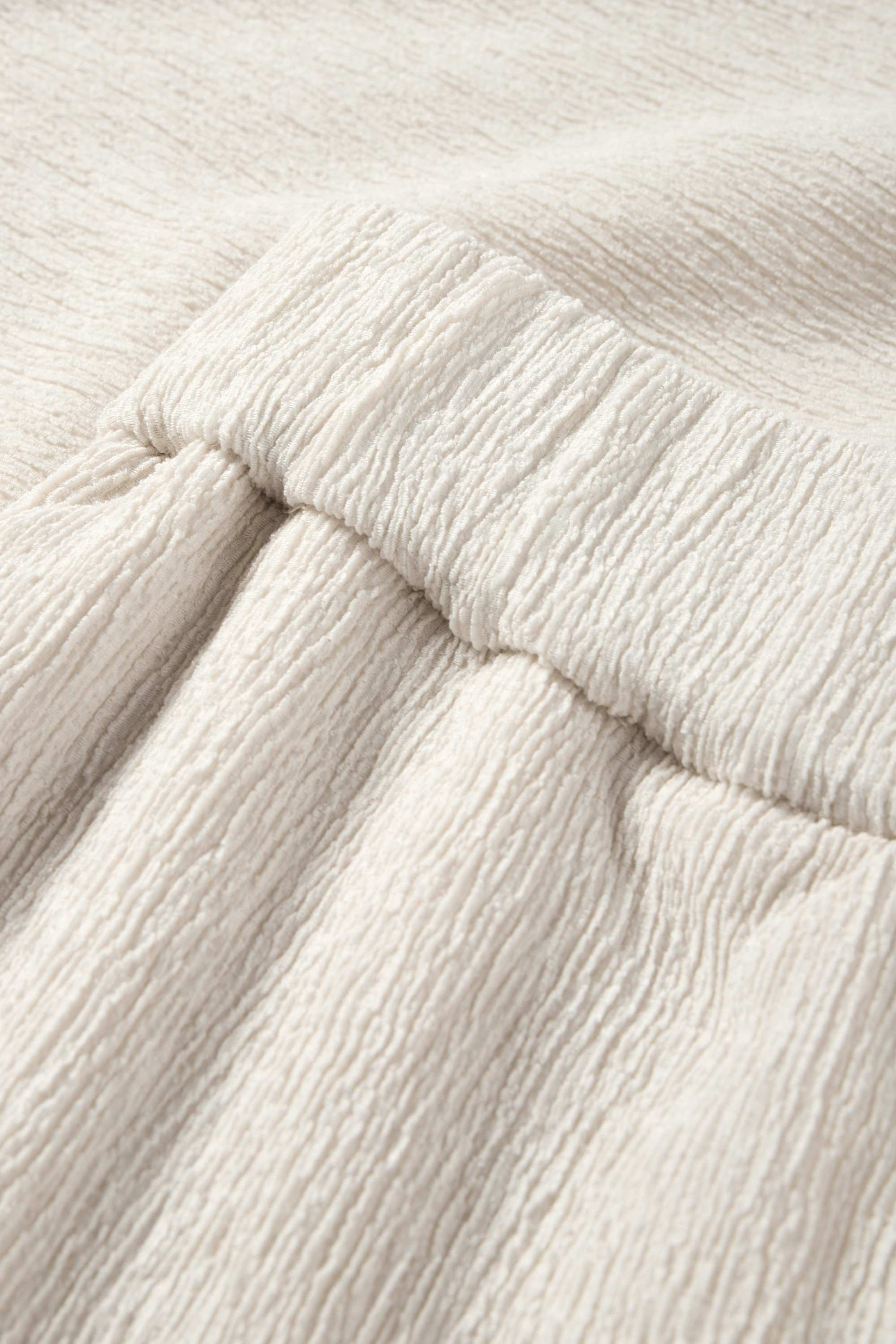Jersey trousers - mid-rise waist - textured light beige