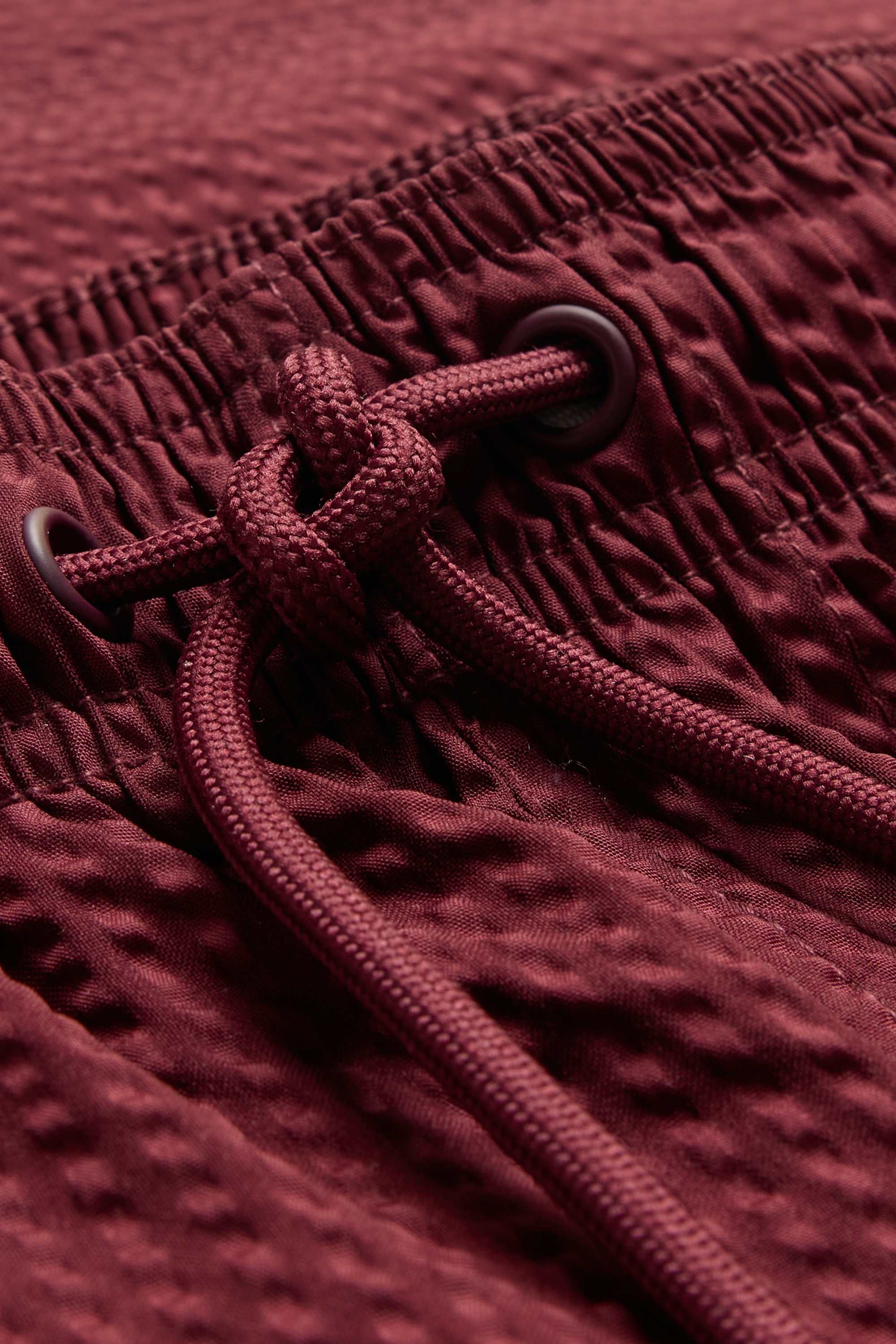 Swim shorts - textured dark red