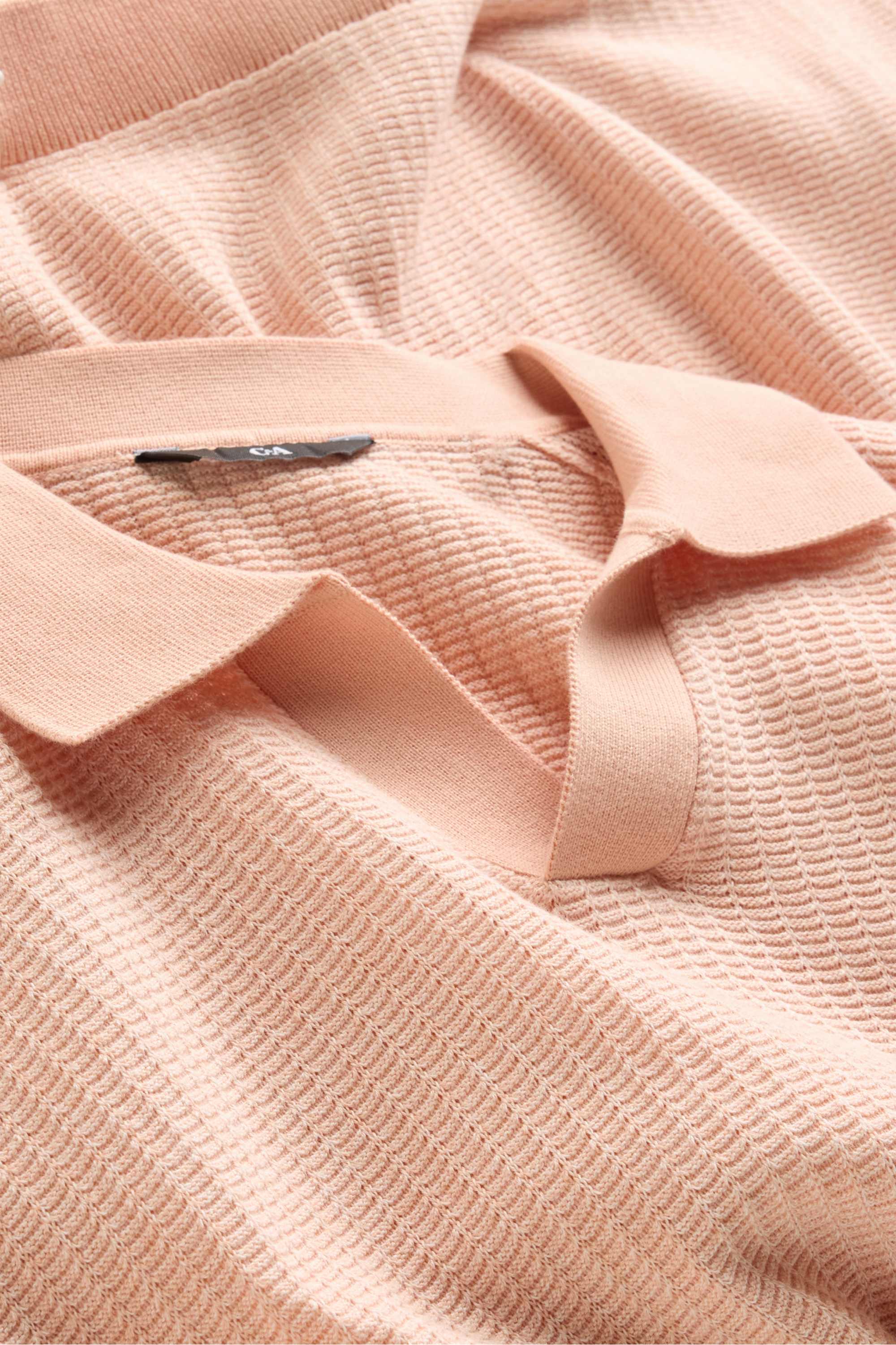 Knitted polo shirt - relaxed fit - textured orange