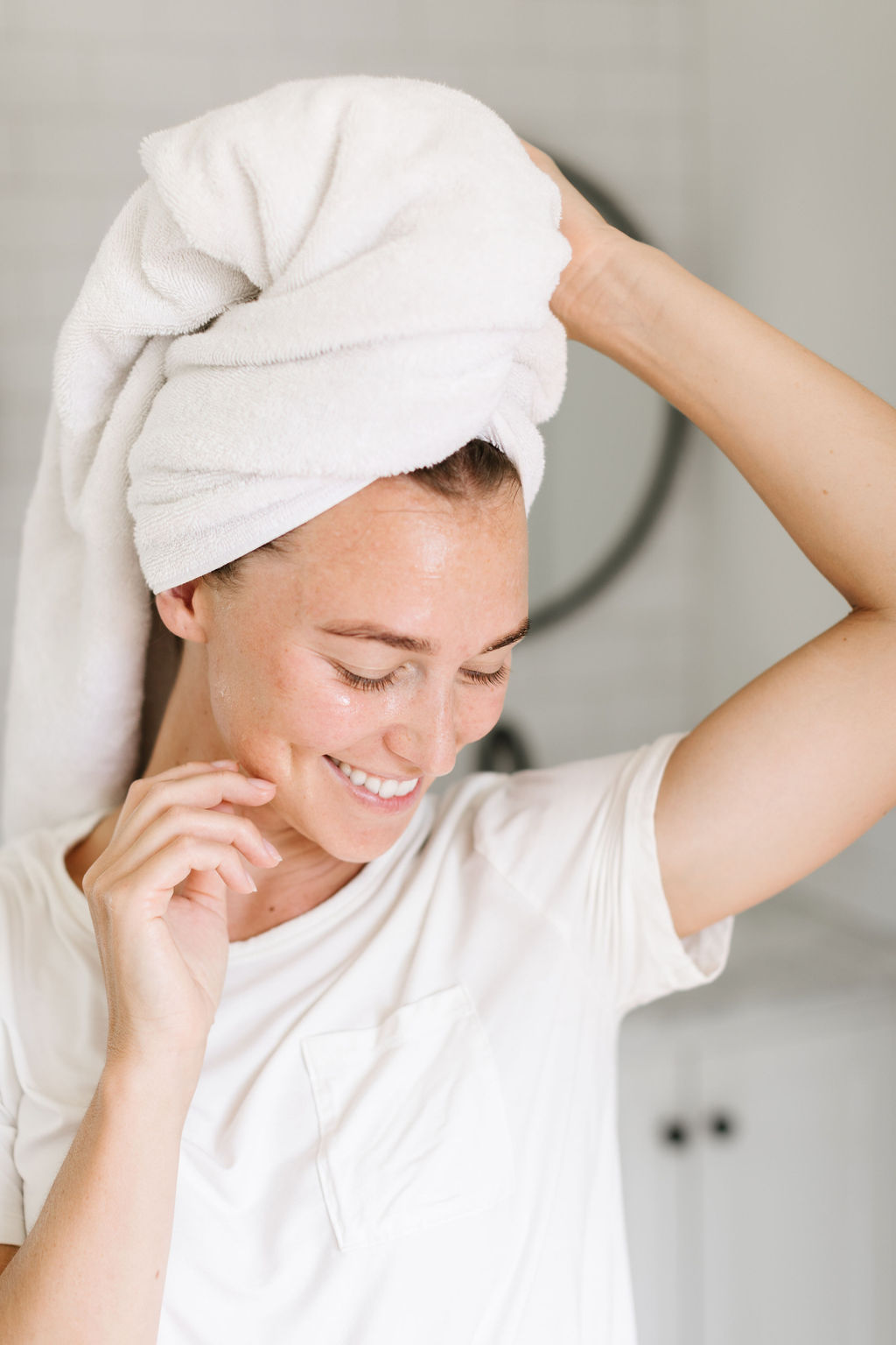 woman smiling with a towel wrapped around her head