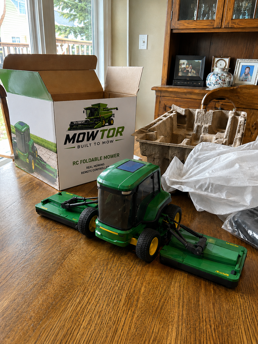 Customer unboxing the green remote-control mower model
