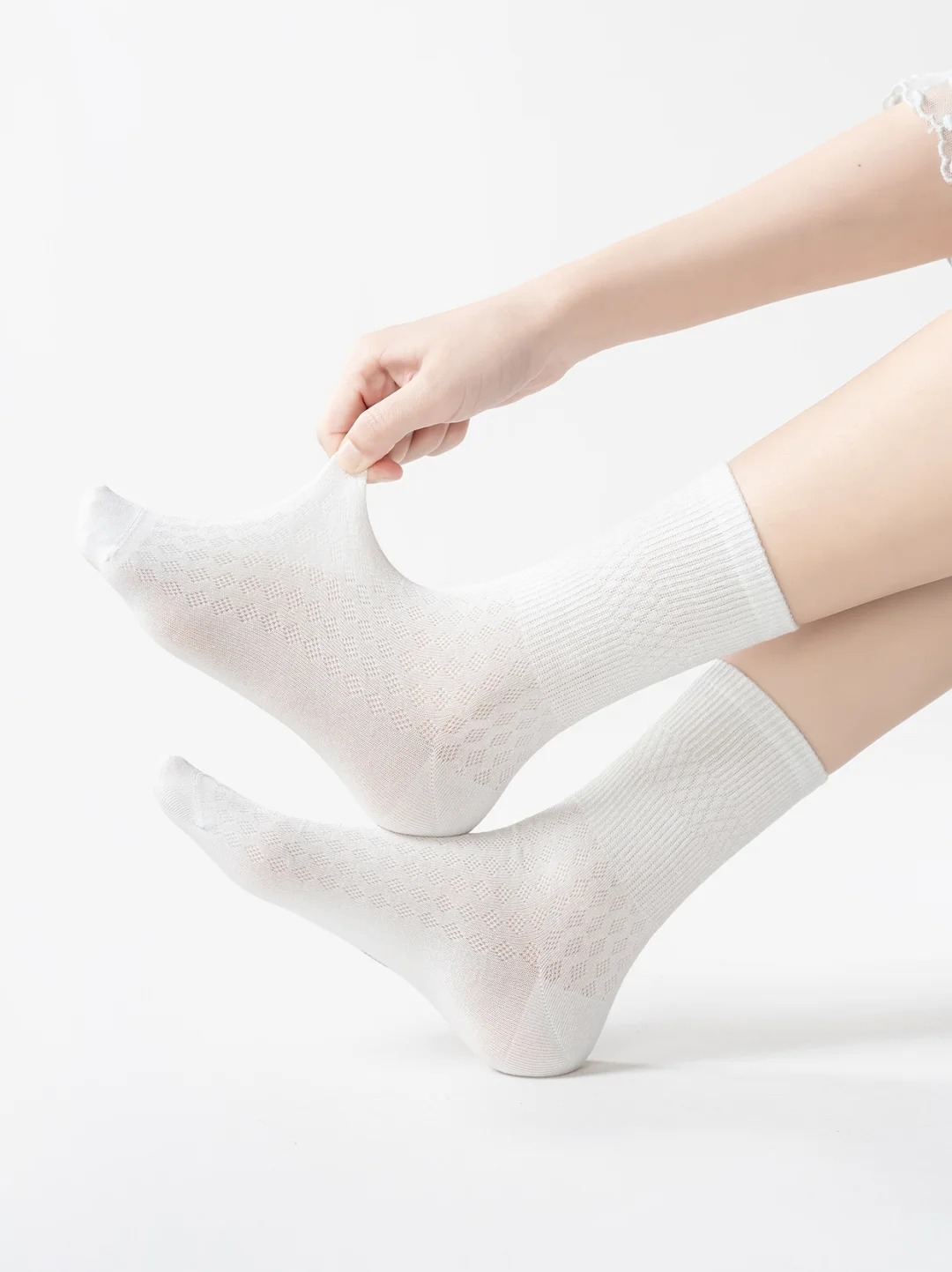 Classic white mid-calf socks with a mesh texture.