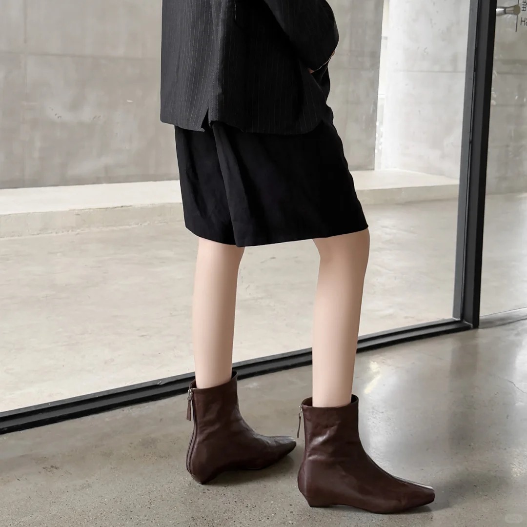 Dark brown leather ankle boots with a back zipper design.