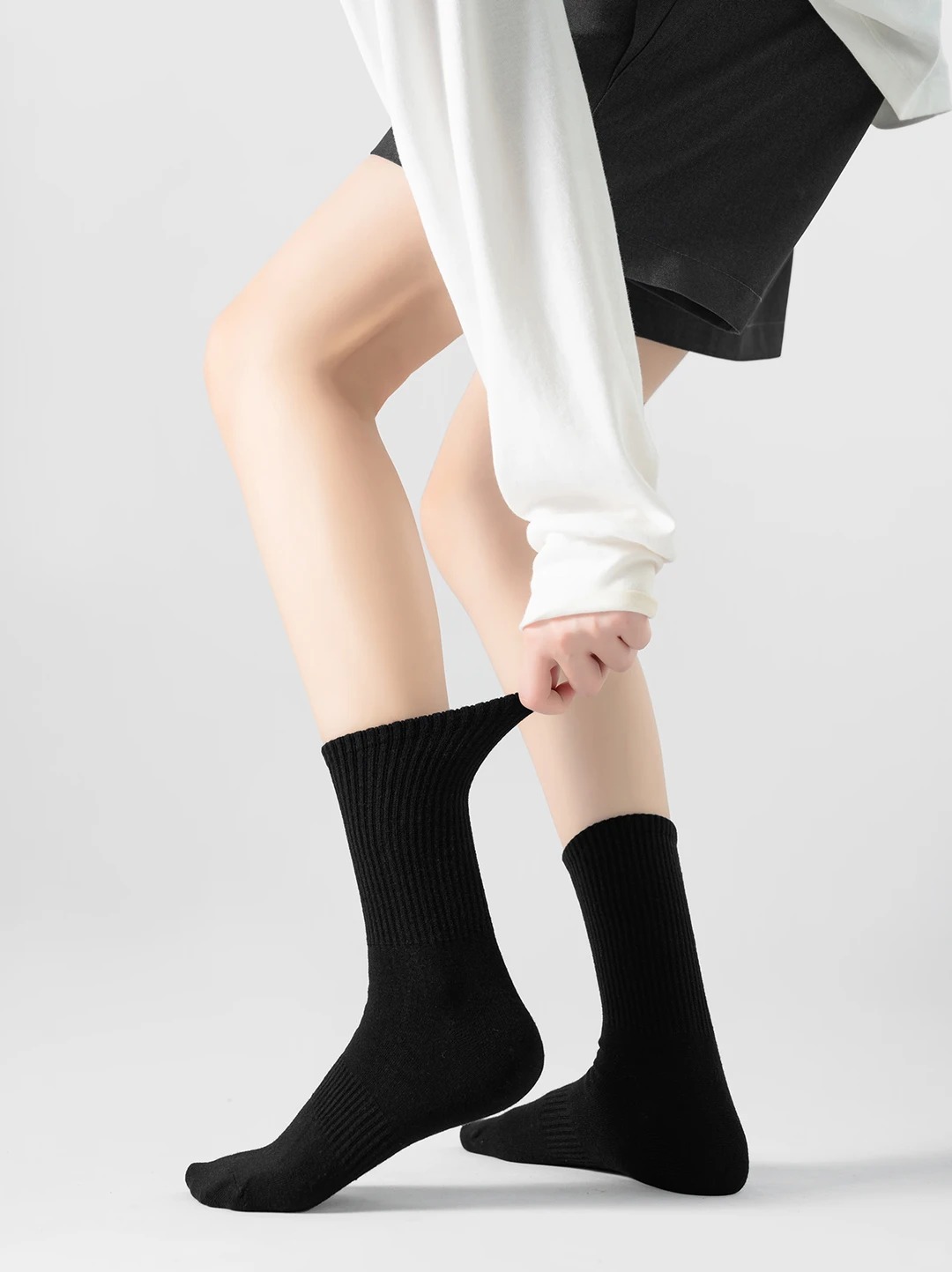 Black mid-calf cotton socks with a vertical ribbed texture