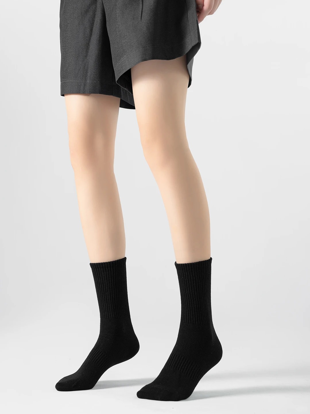 Black mid-calf cotton socks with a vertical ribbed texture