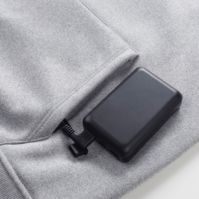 Compact 10,000mAh power bank connected to the heated garment power cable