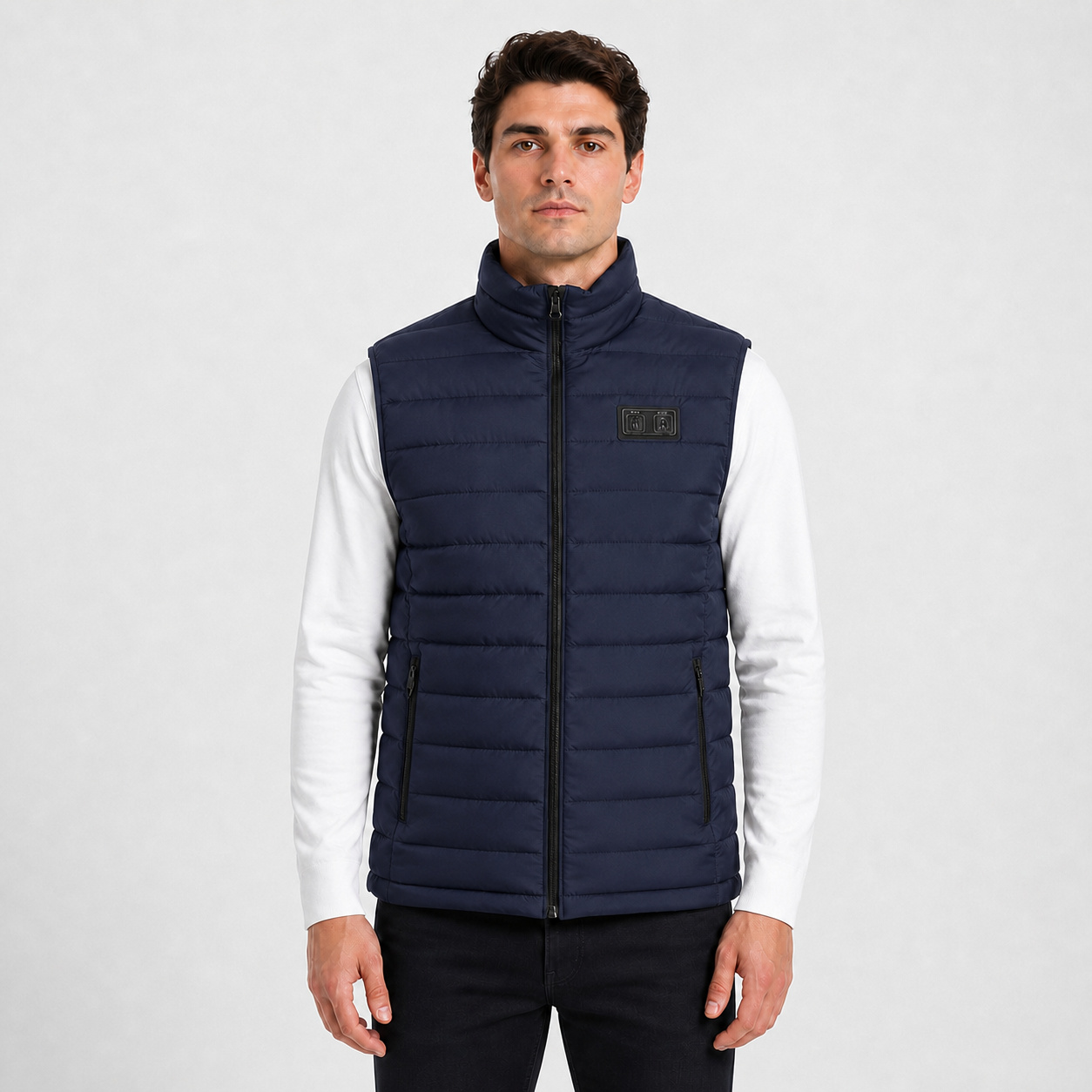 Front view of a male model wearing the blue 15-zone dual-control heated vest.