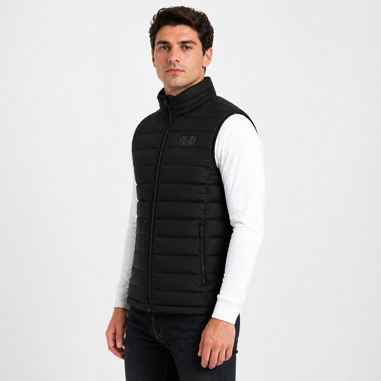Side view of a male model wearing the black heated vest.