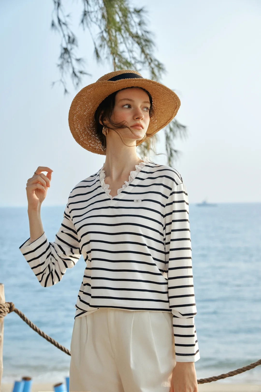 Black and white striped long-sleeved top with white lace details