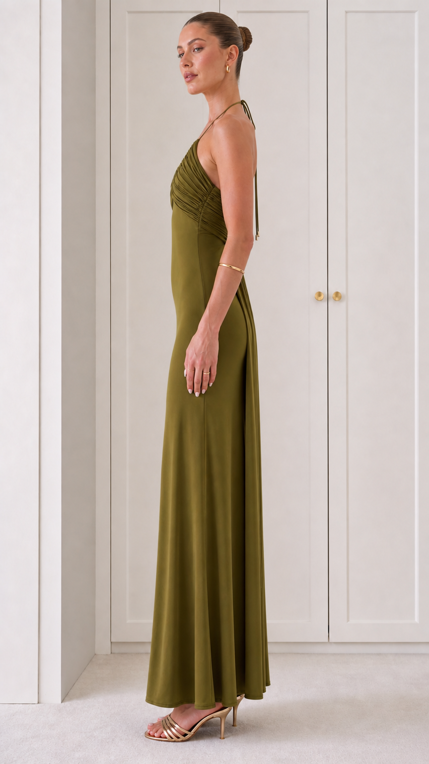 Side view of woman in Olive Green backless halter evening dress