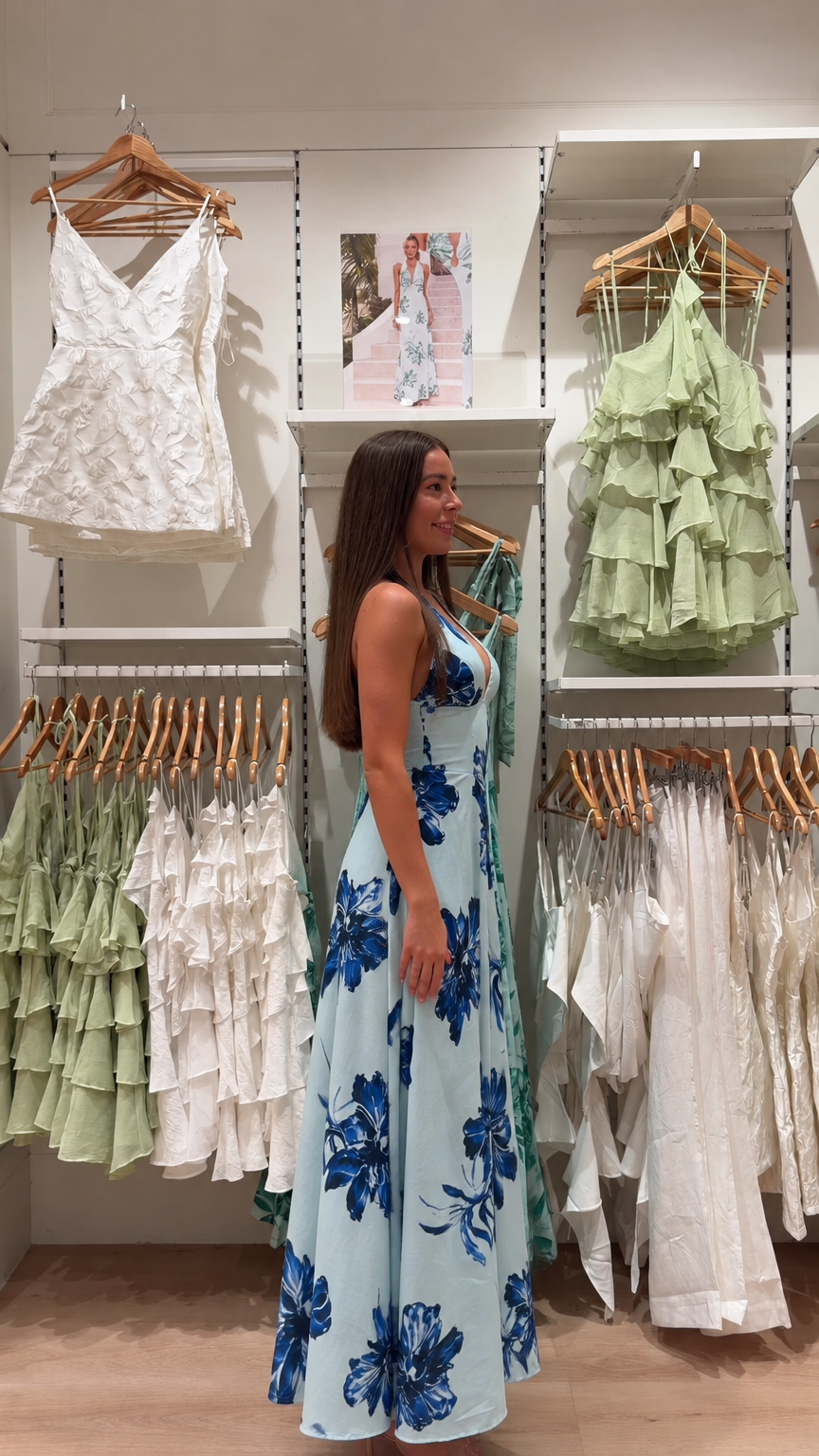 Side profile view of light blue floral halter neck maxi dress
