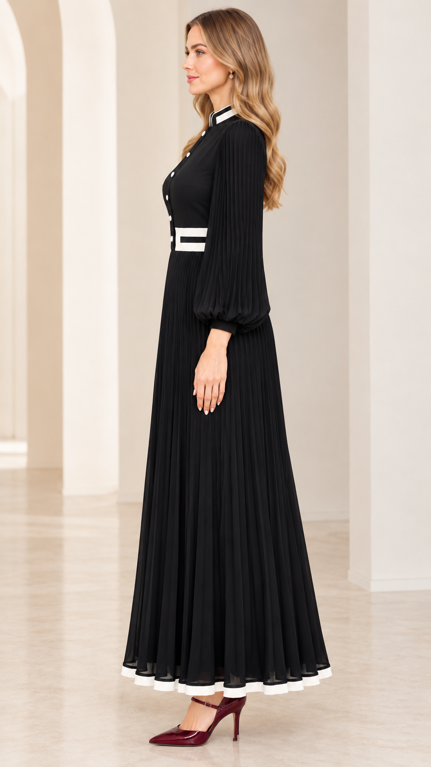 Side profile of woman wearing black accordion-pleated maxi dress with long sleeves