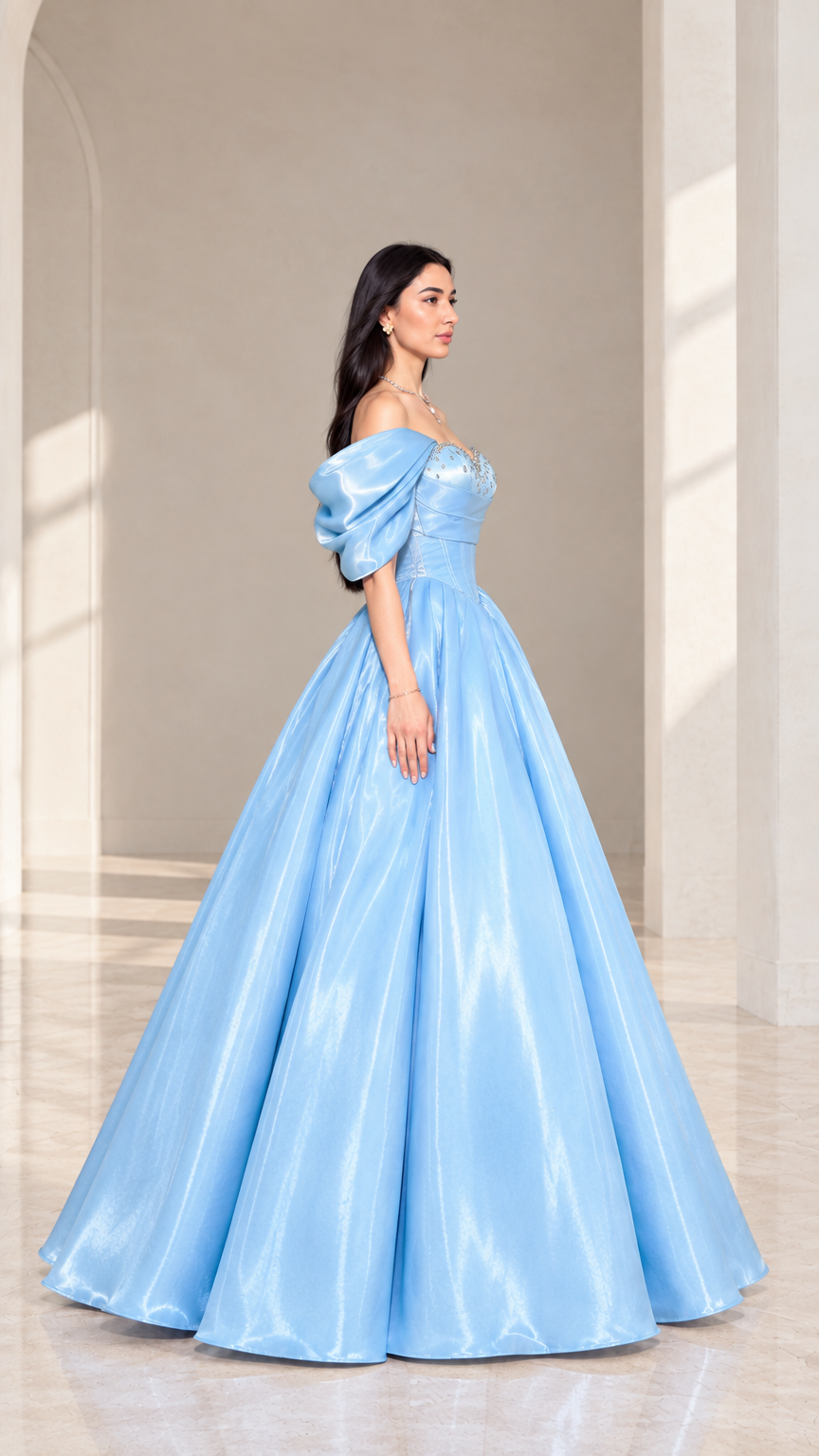Side angle of model in a sky blue off-shoulder satin ball gown showcasing silhouette