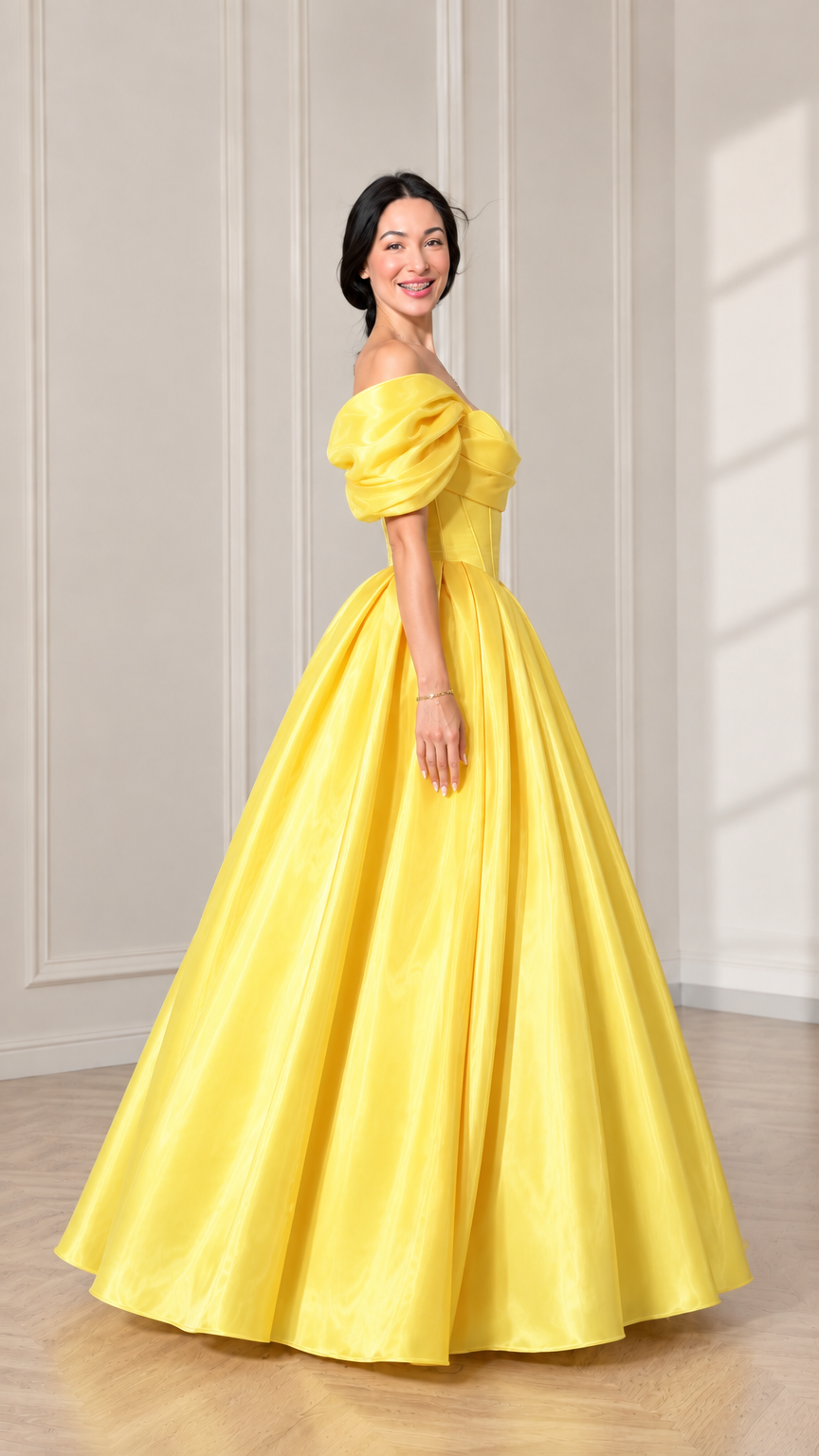 Side profile of model in a yellow floor-length ball gown showing skirt volume