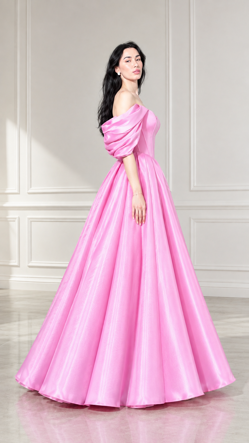 Side profile of woman modeling pink floor-length puff sleeve ball gown