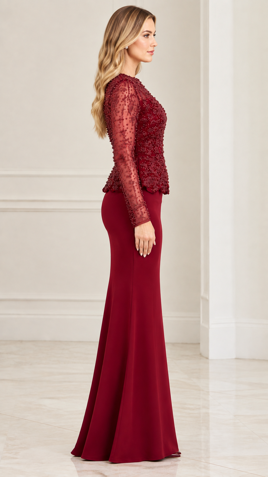 Side profile view of woman wearing burgundy beaded peplum floor-length gown