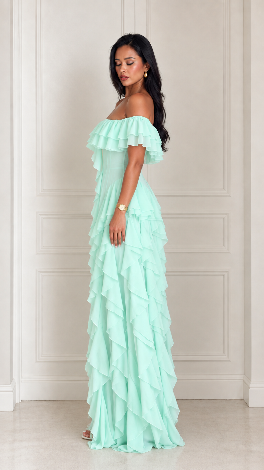 Side profile view of model in a mint green cascading ruffle maxi dress