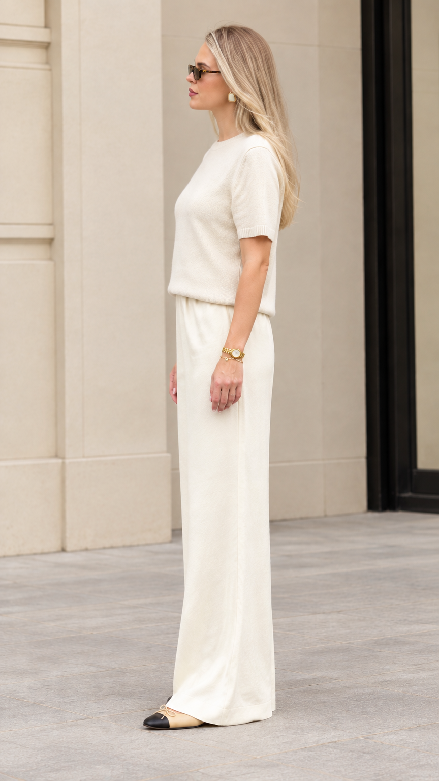 Side profile view of women's cream matching knit two-piece lounge set