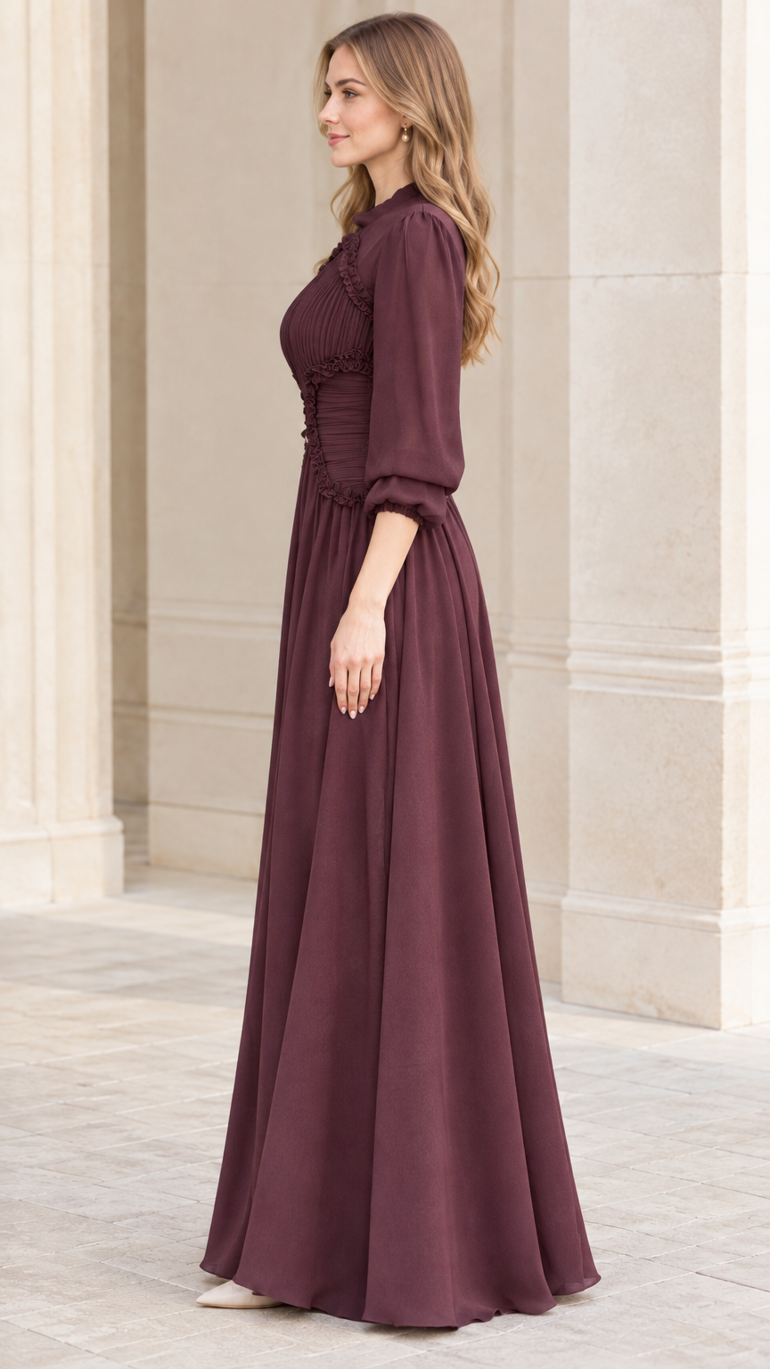 Side view of woman wearing burgundy long sleeve evening gown