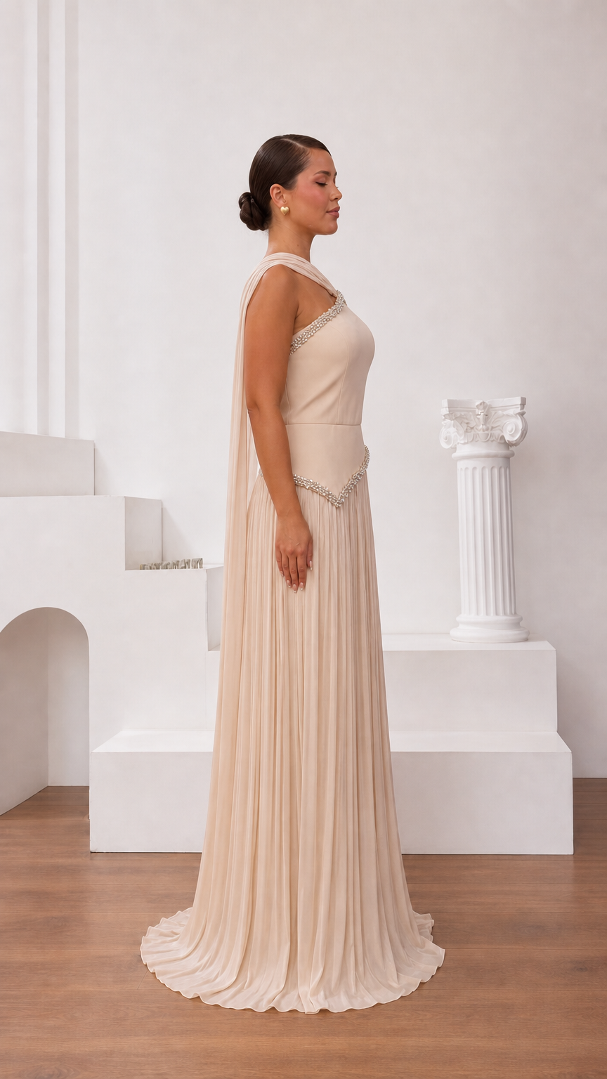 Side profile view of champagne formal dress showing elegant back drape