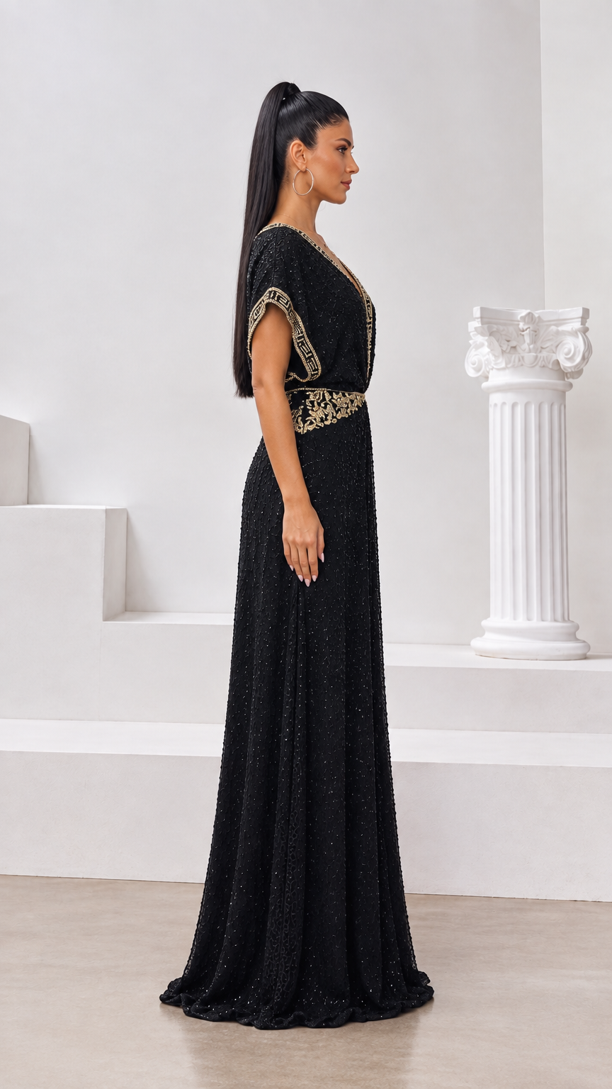 Side profile view of woman modeling the black embroidered glitter maxi dress