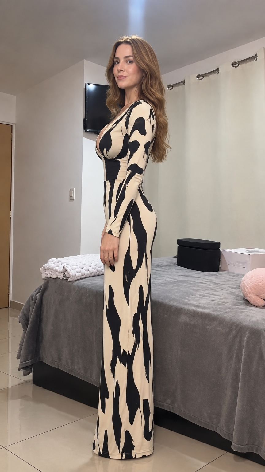 Side profile view of model in beige and black plunge neck wide leg jumpsuit