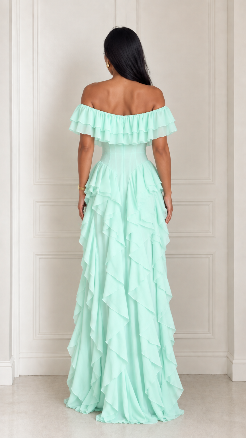 Rear view of model showing back details of mint green off-the-shoulder ruffle dress
