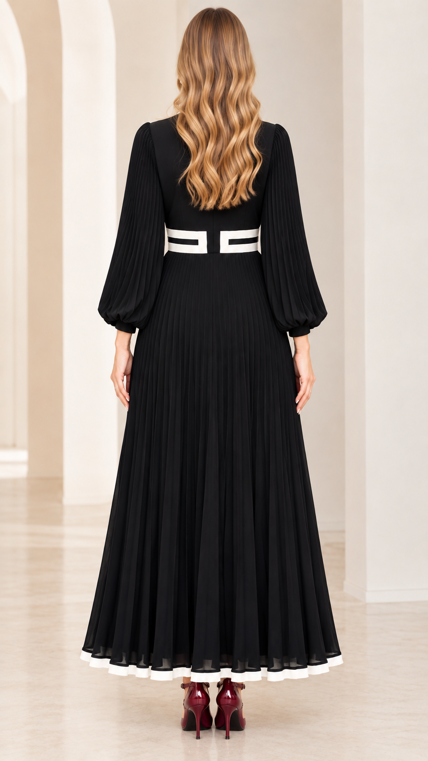 Back view of black long sleeve pleated maxi dress showing flattering drape and silhouette