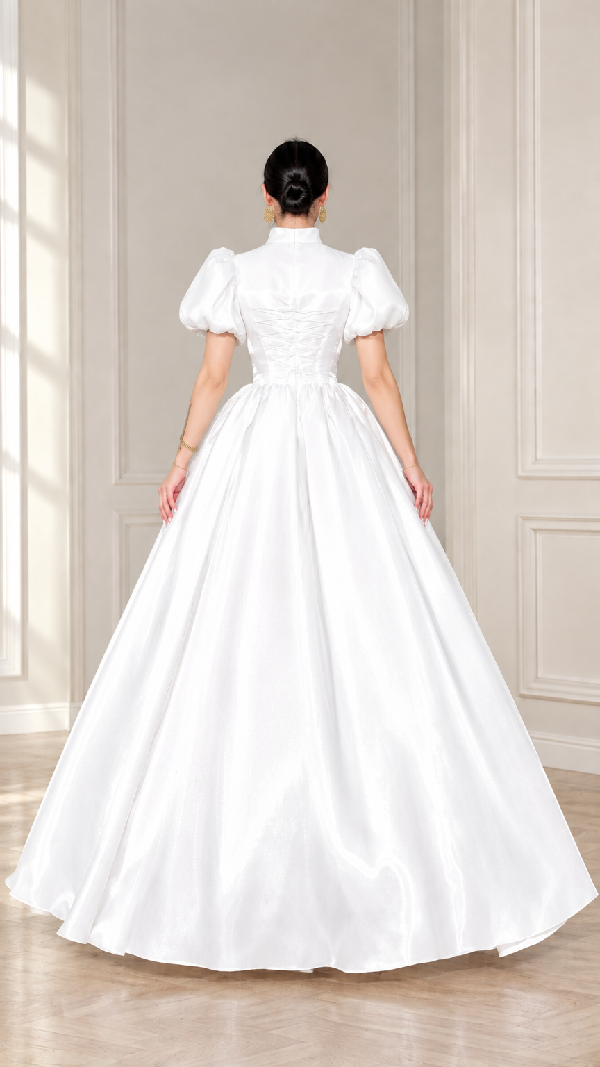 Back view of white satin ball gown showing lace-up corset detail