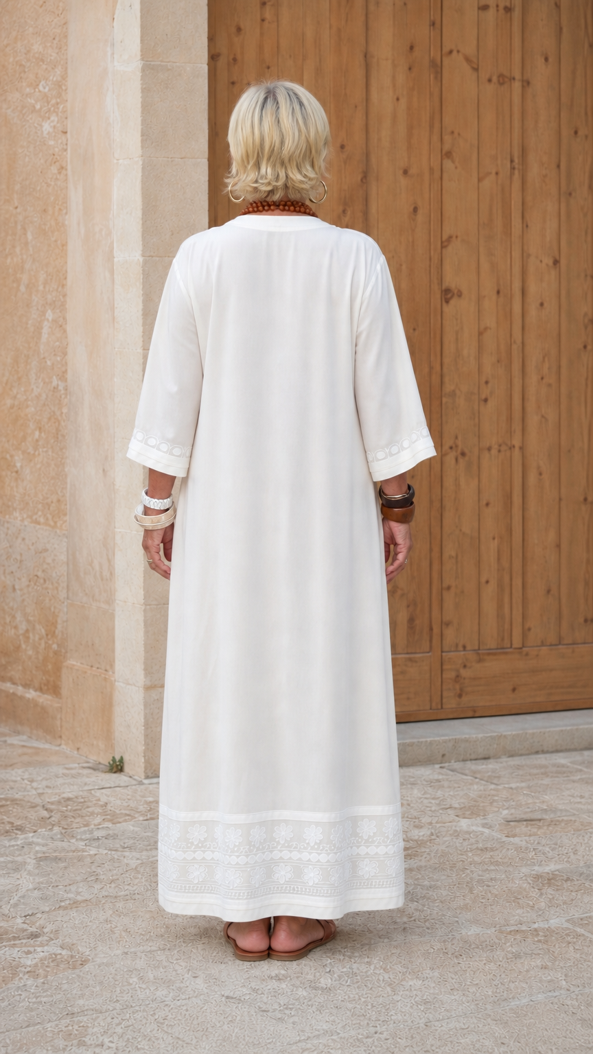 Back view of woman wearing white relaxed kaftan maxi dress