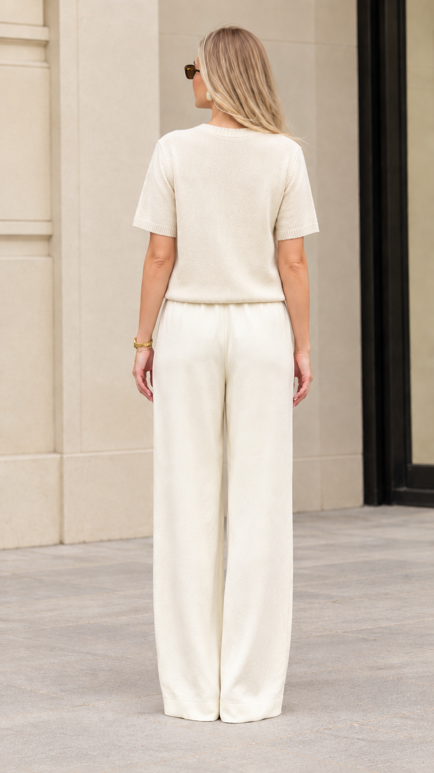 Back view of women's cream short sleeve top and wide leg knit trouser set