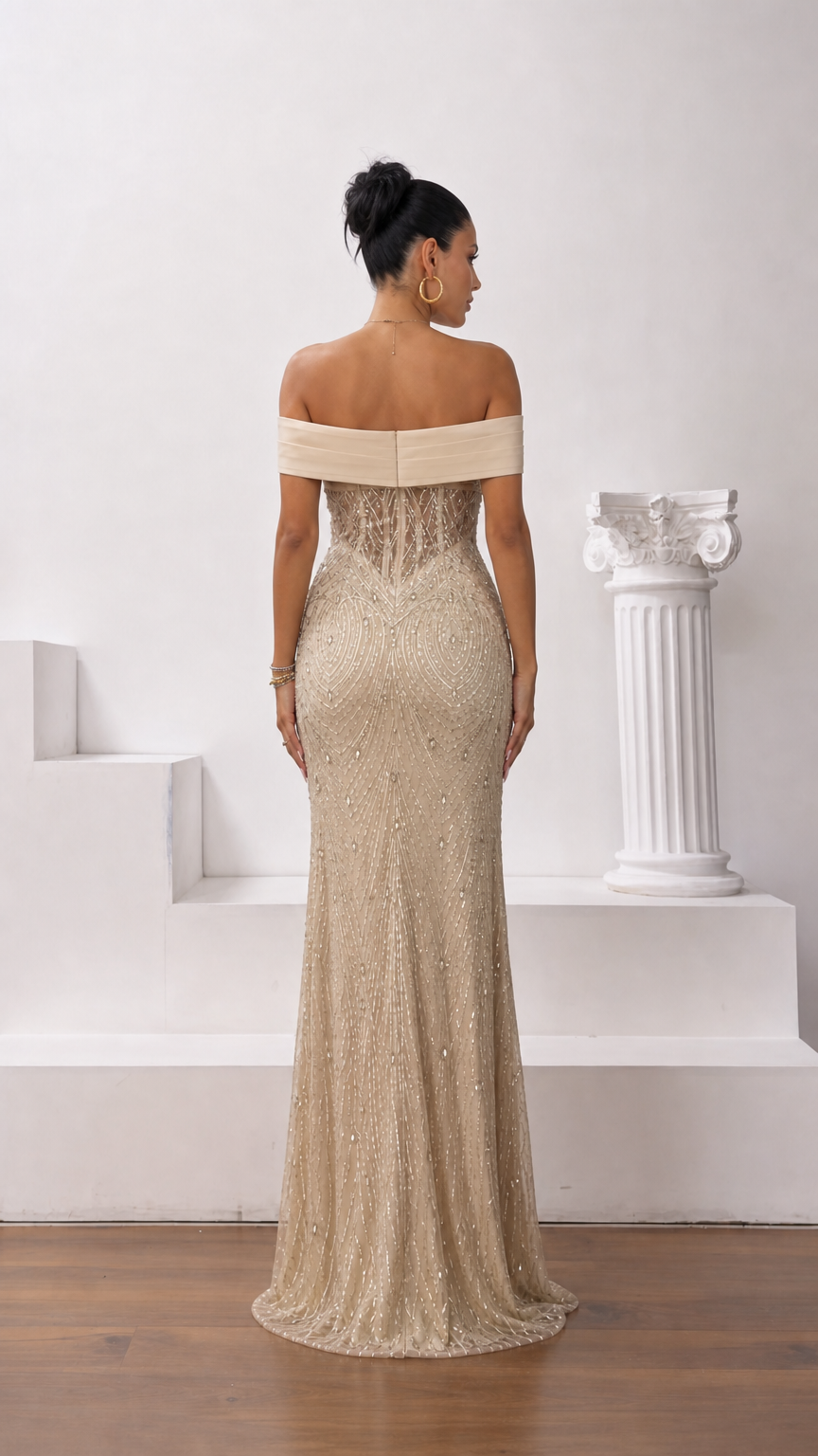 Back view of champagne gold off-the-shoulder beaded evening gown showing sleek fit