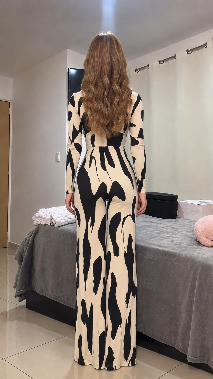 Back view of model showcasing beige and black long sleeve fitted jumpsuit