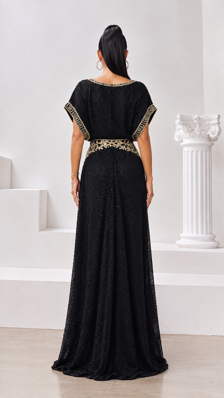 Back full-length view of the black evening maxi gown showing back waist embroidery